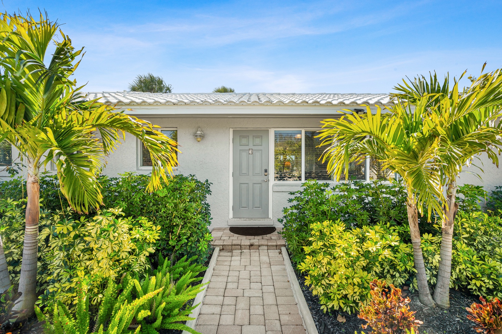 Tropical paradise awaits at this charming beachside bungalow, where swaying palms and lush gardens create your perfect island getaway.