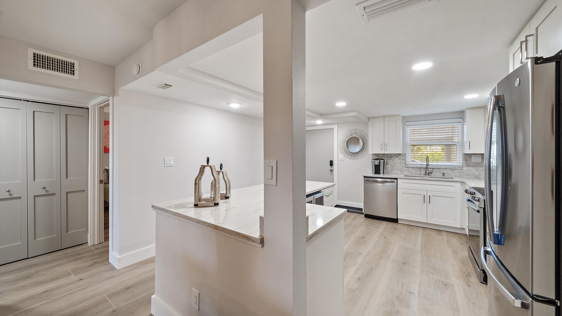 Your modern kitchen awaits with sleek white cabinets, marble countertops, and stainless steel appliances for memorable meals.