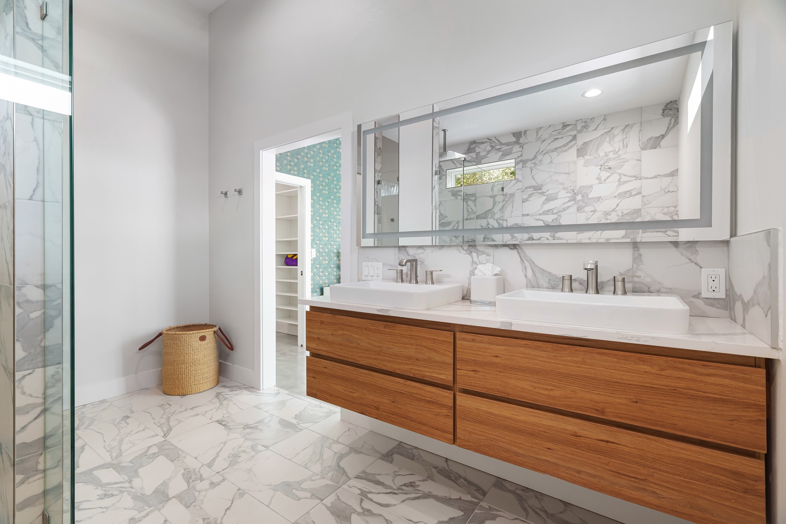 Step into your private spa-like sanctuary where marble gleams, dual vanities offer plenty of space, and warm wood tones invite relaxation after a day of adventure.