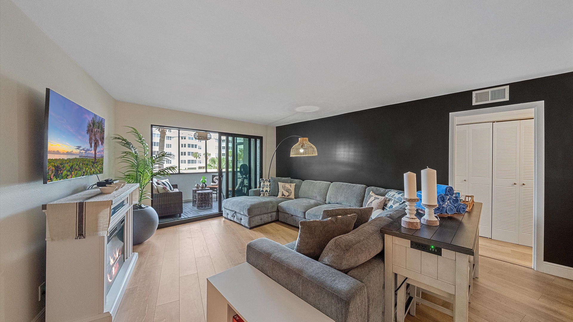 Relax in your stylish living room with modern furnishings, a cozy fireplace, and large windows offering city views.