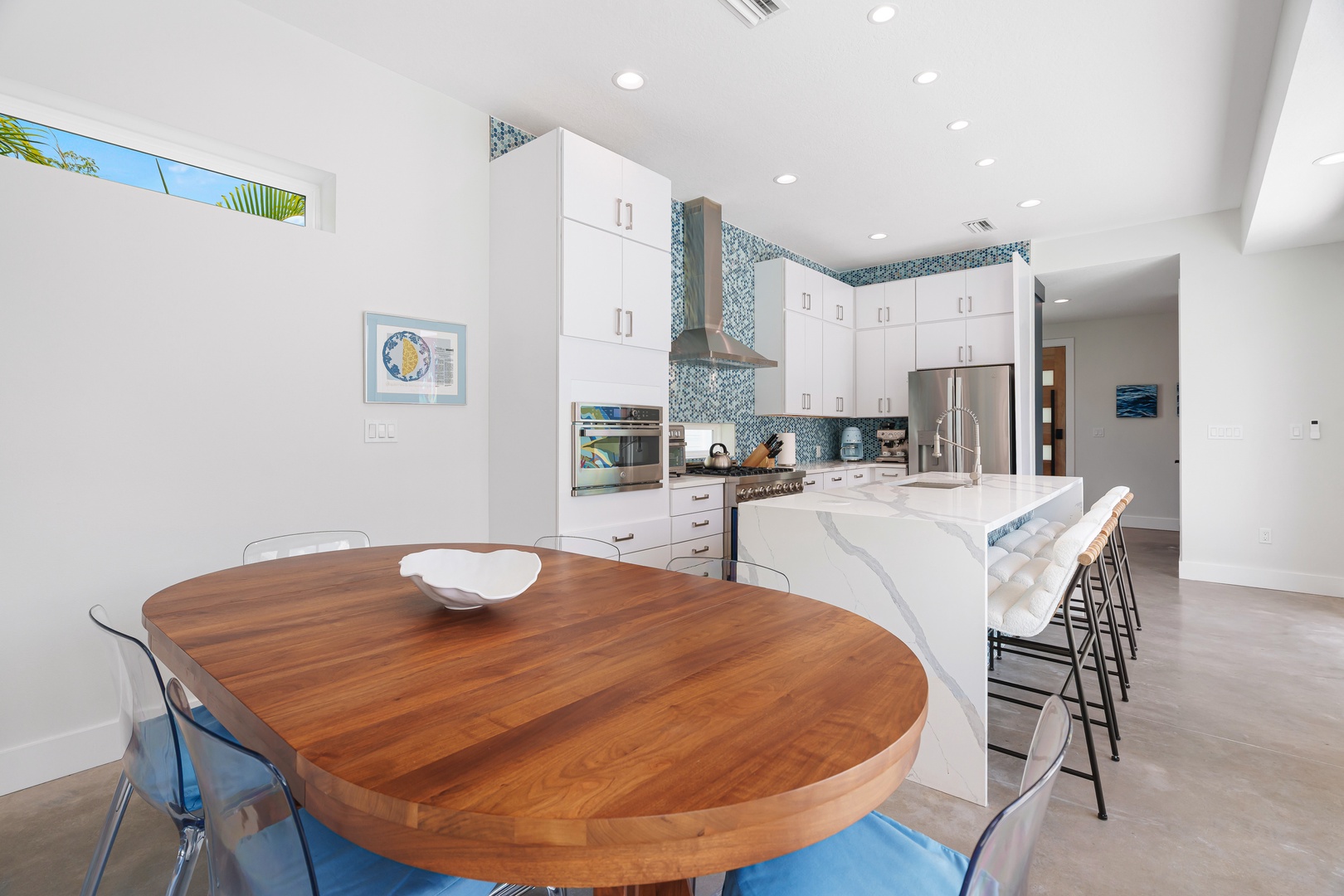 Gather around this stunning open kitchen where the elegant marble island and mosaic backsplash invite you to enjoy preparing your favorite meals in a space that feels both modern and welcoming.