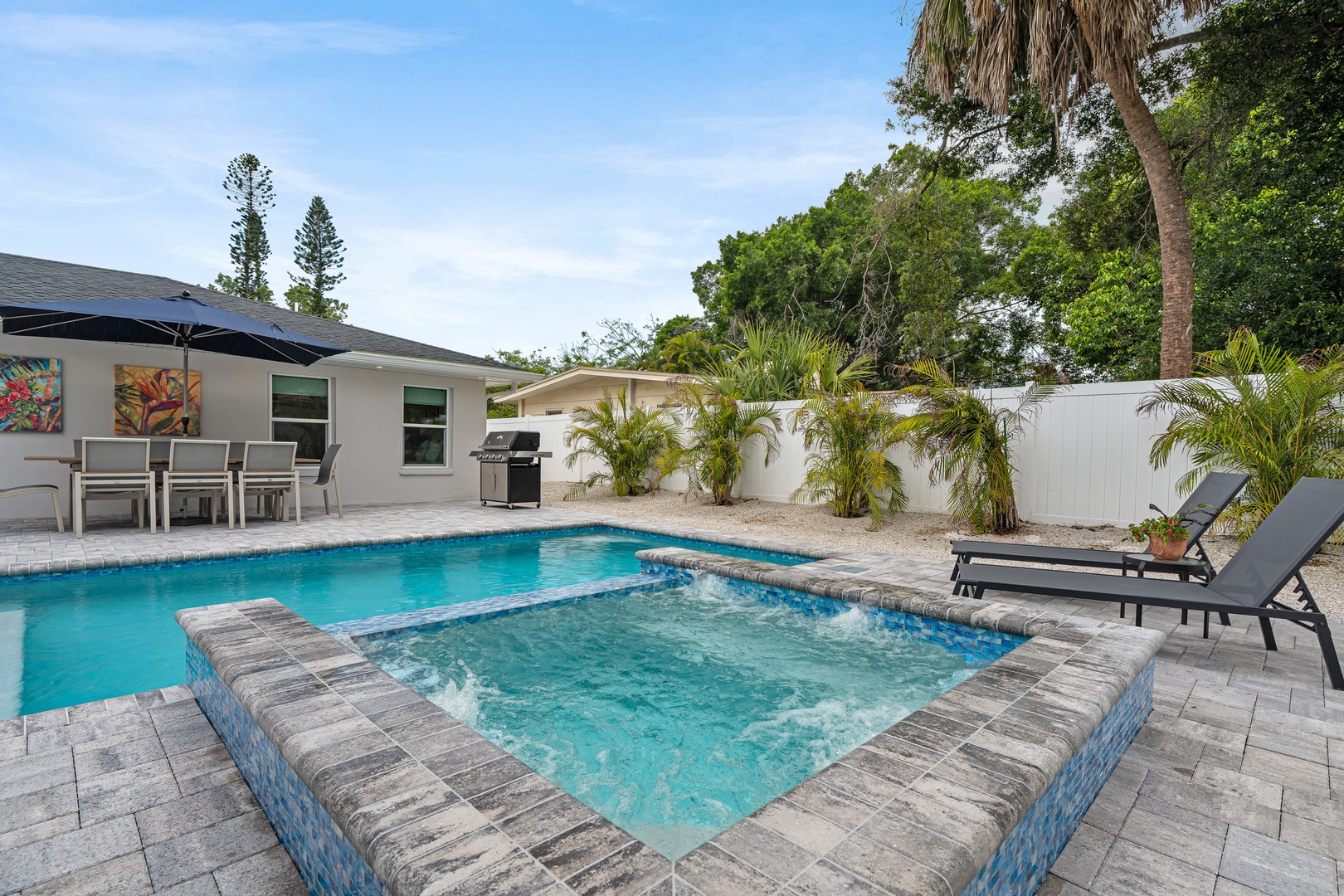 Take a refreshing dip in your private pool, surrounded by tropical palms and a shaded patio perfect for alfresco dining.