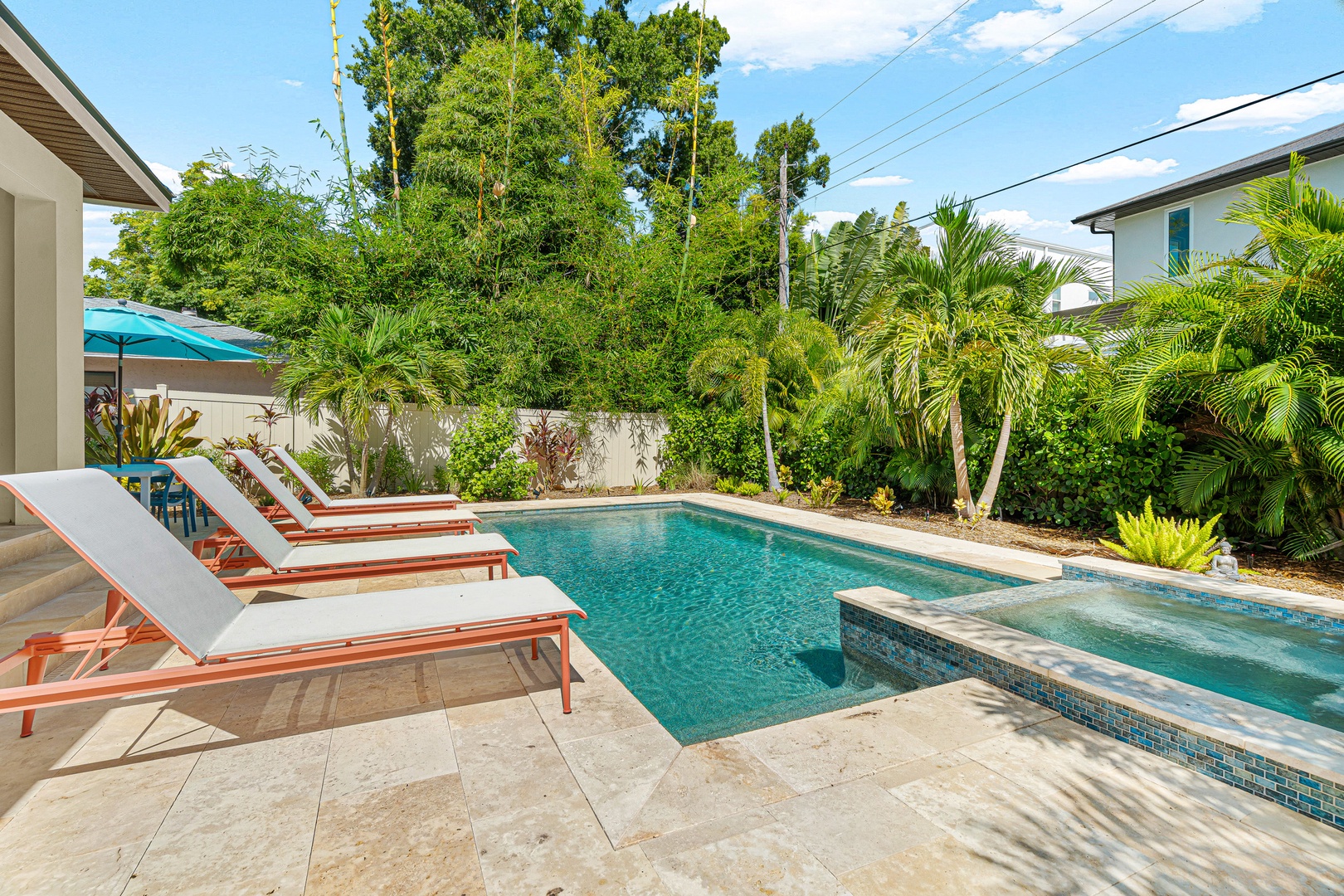 Your private oasis awaits—lounge poolside surrounded by lush tropical palms and vibrant greenery. The sparkling pool and sunny deck invite you to relax, refresh, and soak in the warm Florida vibes.