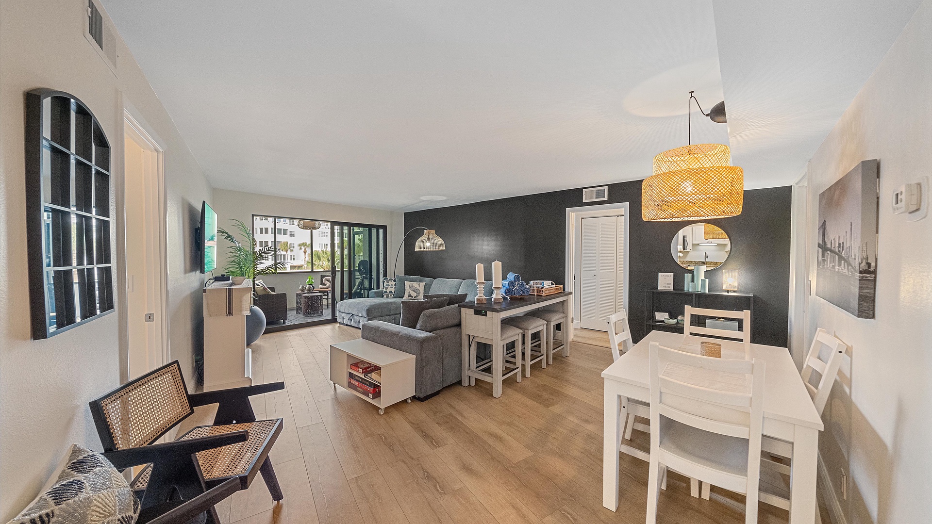 Relax in this beautifully designed open-concept living space where you can unwind on the comfortable sectional sofa and enjoy meals at the stylish dining table.