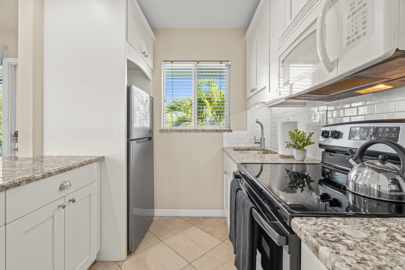 Your fully equipped galley kitchen features granite countertops and stainless appliances, perfect for preparing meals during your stay.