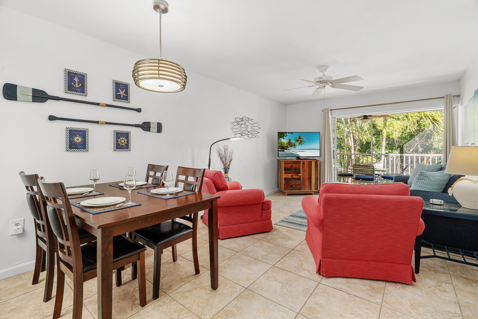 Bright, nautical-themed living space invites relaxation with private patio access.