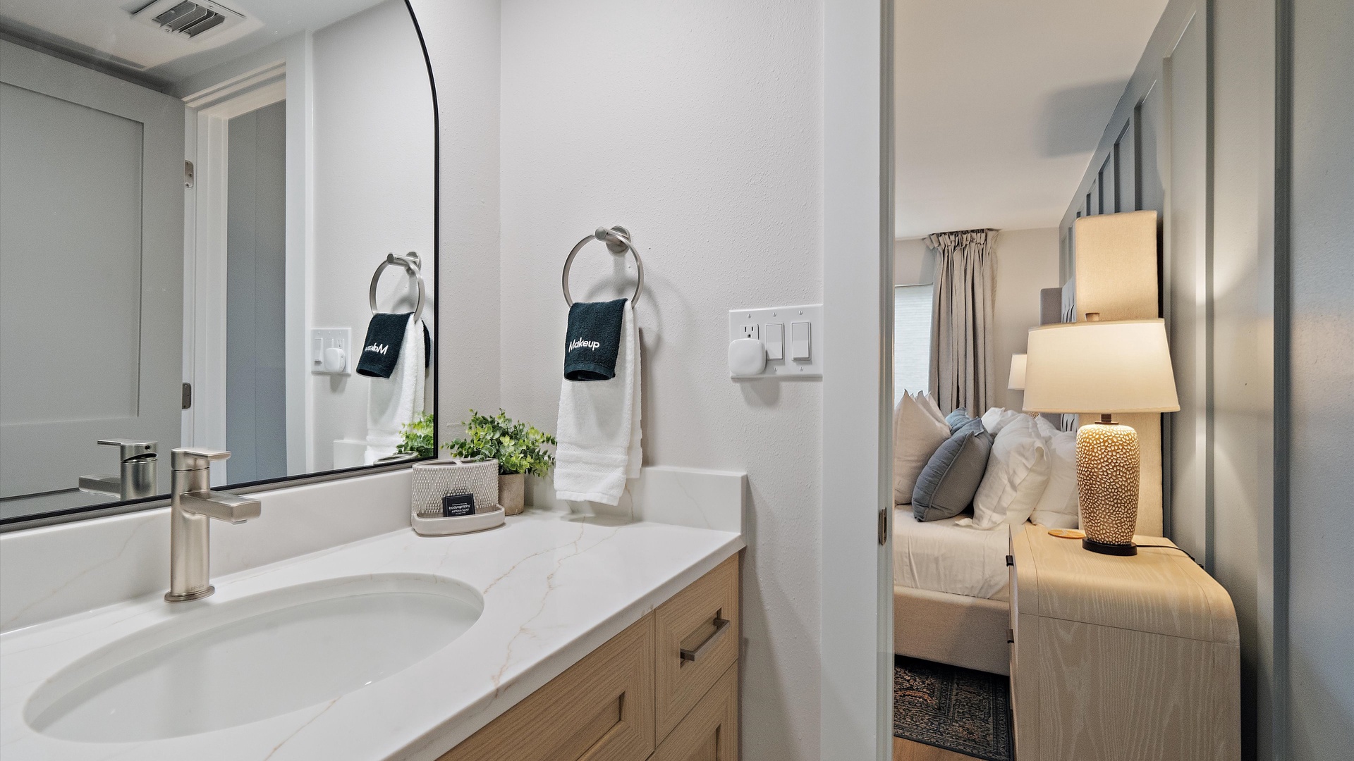 Refresh in your private bathroom featuring a sleek vanity and modern fixtures, then sink into the comfortable bedroom just steps away.