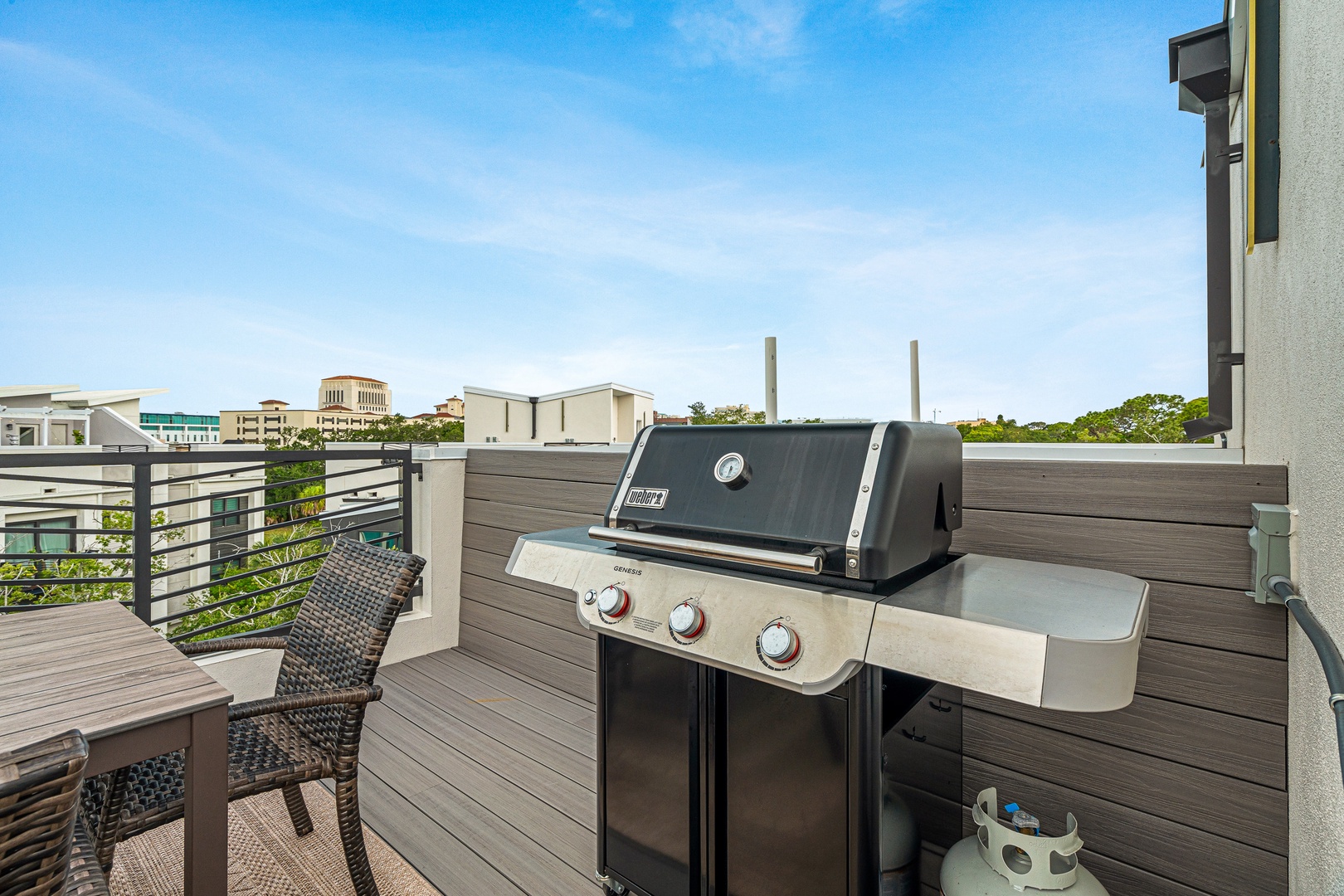 Your private rooftop deck comes equipped with a BBQ grill and terrace seating, perfect for outdoor dining while enjoying the surrounding neighborhood views.