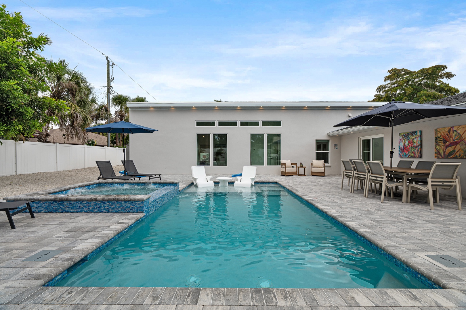 Modern waterfront home with a sparkling private pool, and spacious patio perfect for sunny afternoons and tropical relaxation.