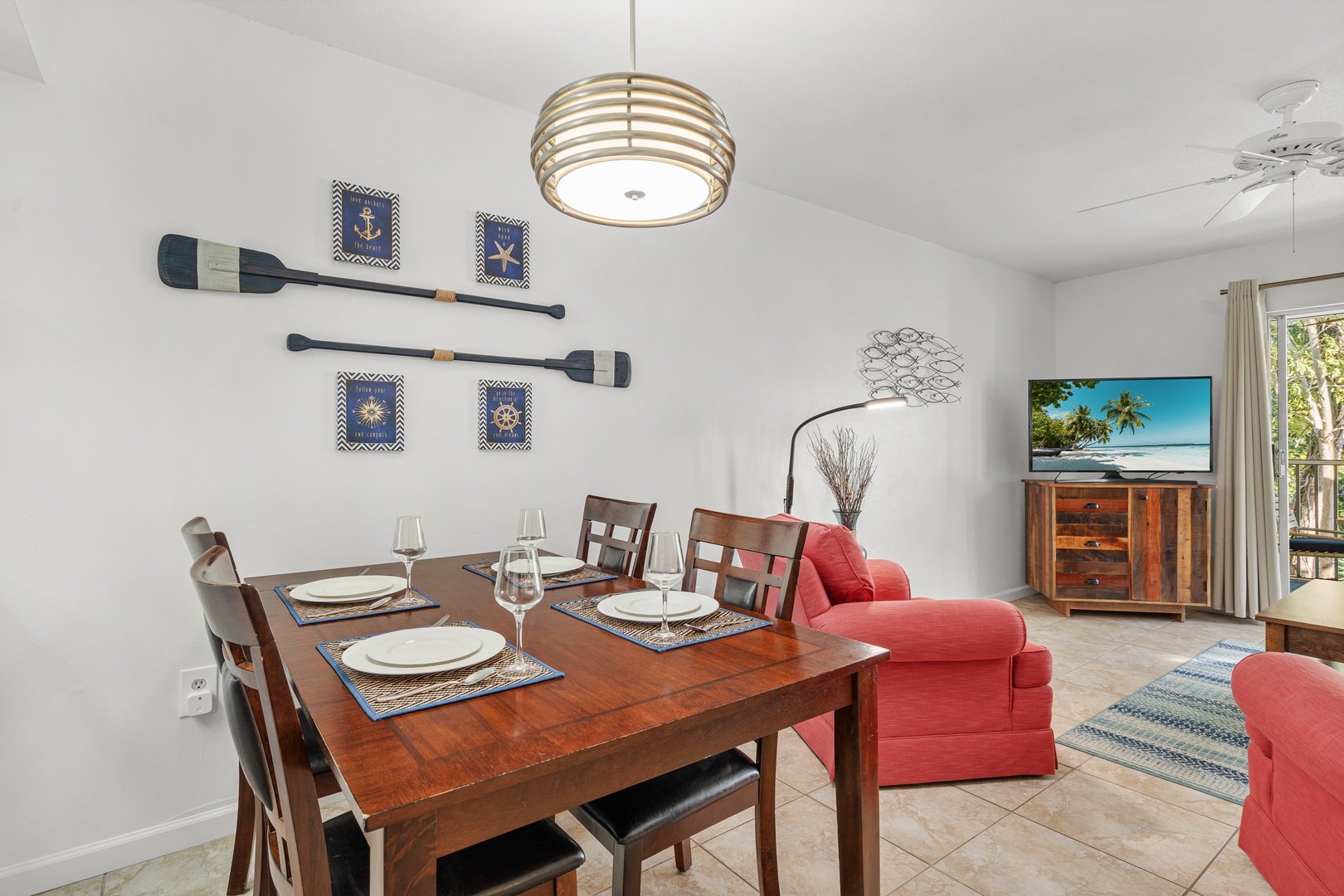 Your spacious dining and living area features coastal charm with nautical decor, comfortable seating, and entertainment for memorable evenings together.