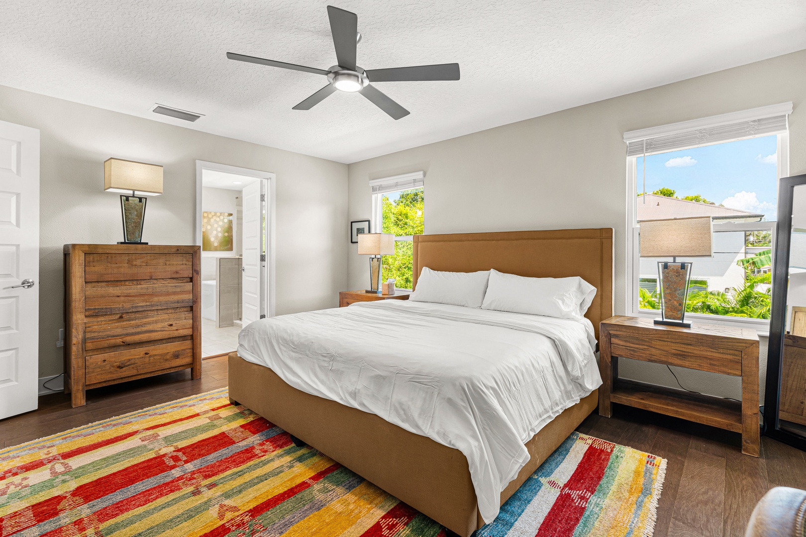 Sink into crisp white linens and wake up refreshed in your peaceful bedroom, where warm wood tones and natural light create the perfect retreat after your daily adventures.