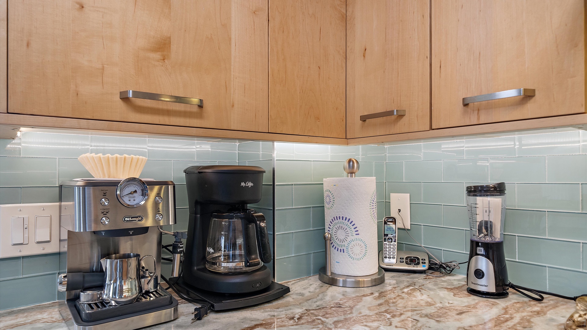 Start your mornings right with premium coffee facilities and sleek appliances at your fingertips in this beautifully appointed kitchen.