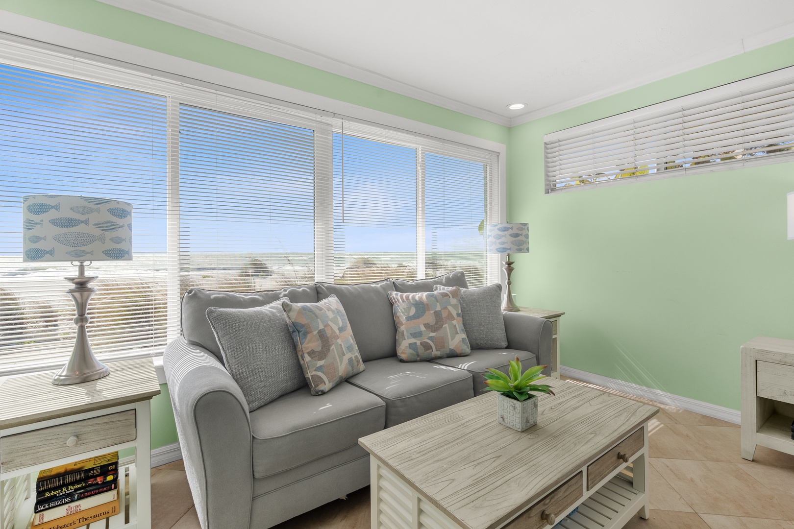 Relax in your bright living space with panoramic oceanfront views.