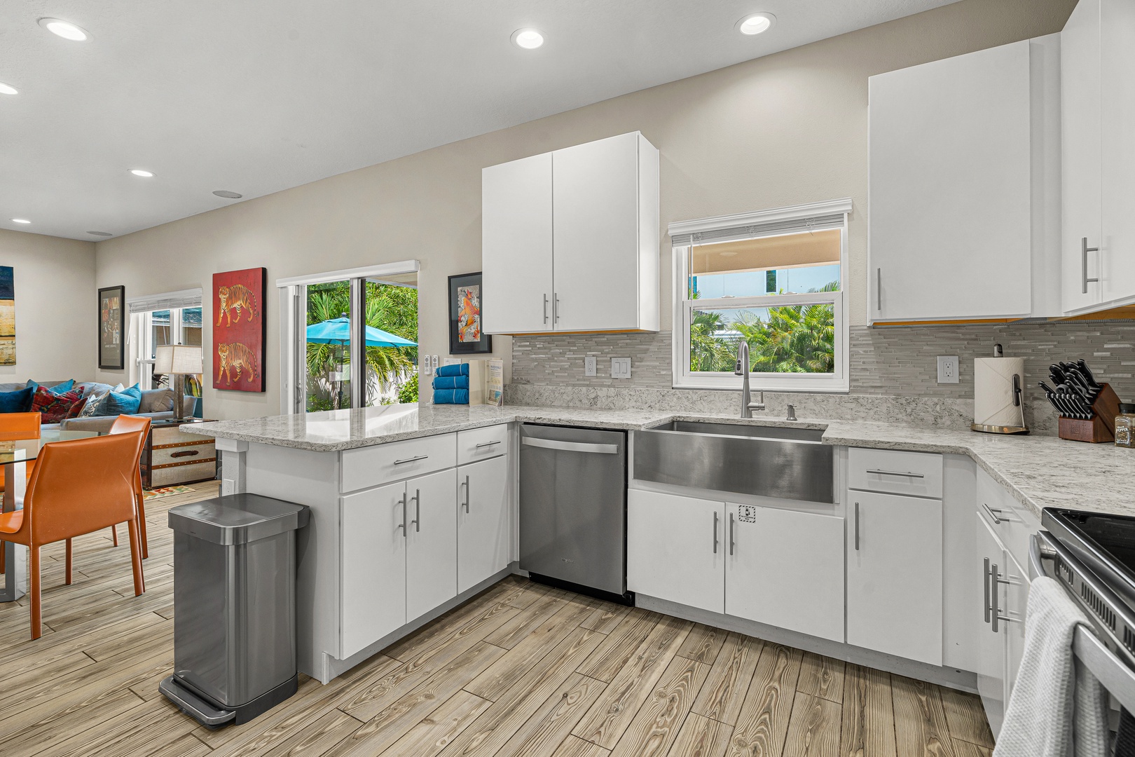 Sunshine streams through the windows of your bright, modern kitchen, where sleek white cabinetry and gleaming granite counters invite you to whip up a delicious meal. Open to the living area, it's perfect for gathering with loved ones.