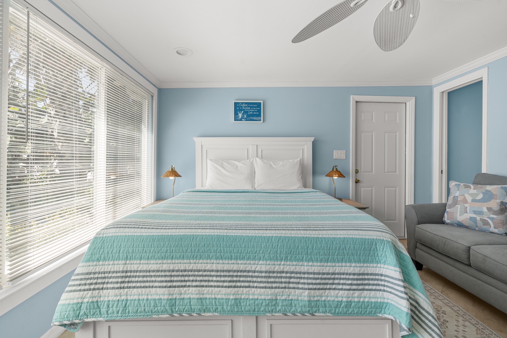 Drift off to sleep in this serene bedroom where soft coastal blues and crisp white linens create your perfect seaside retreat.