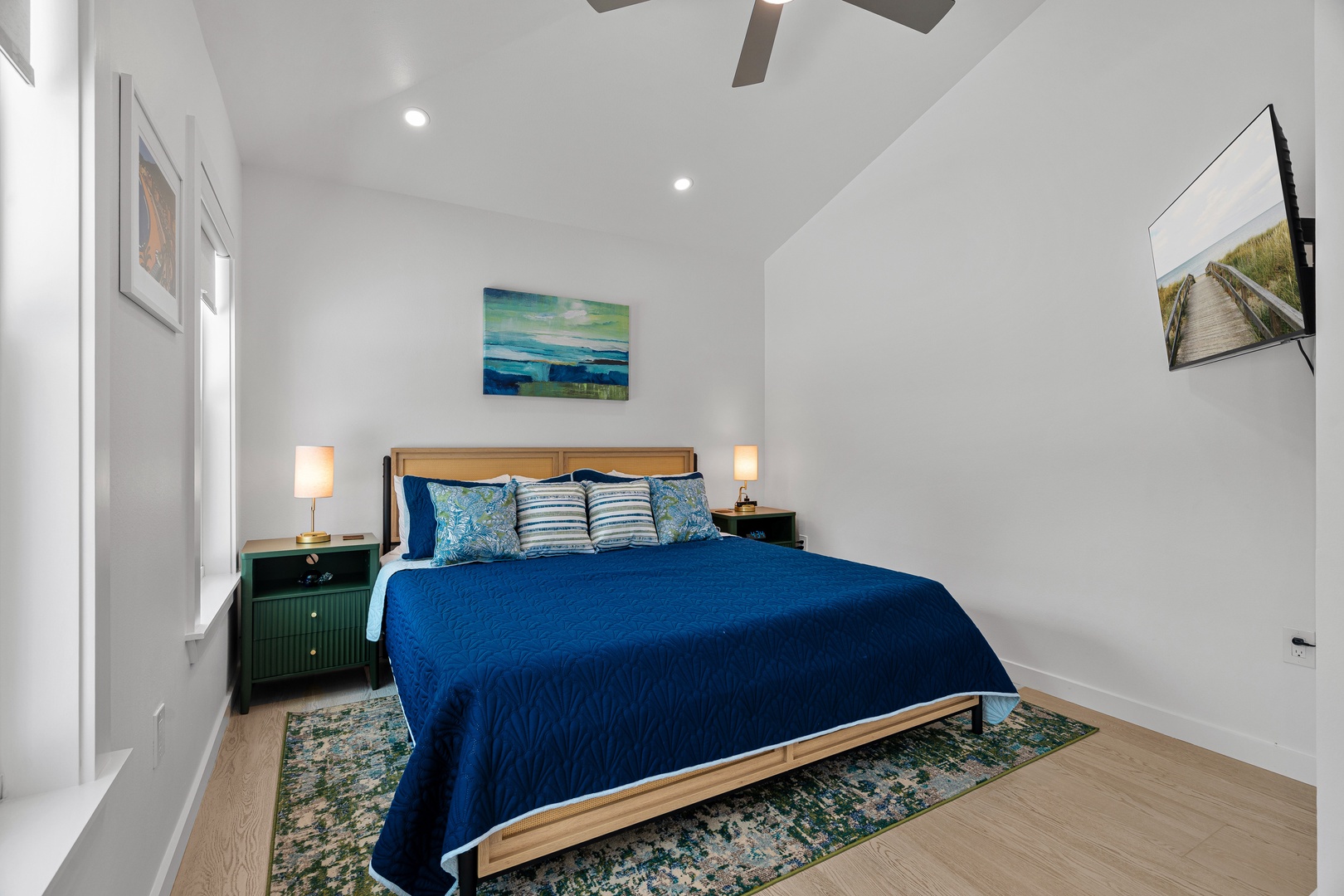 Sink into this plush bed with coastal artwork and vaulted ceilings creating a breezy, open atmosphere for your perfect getaway retreat.