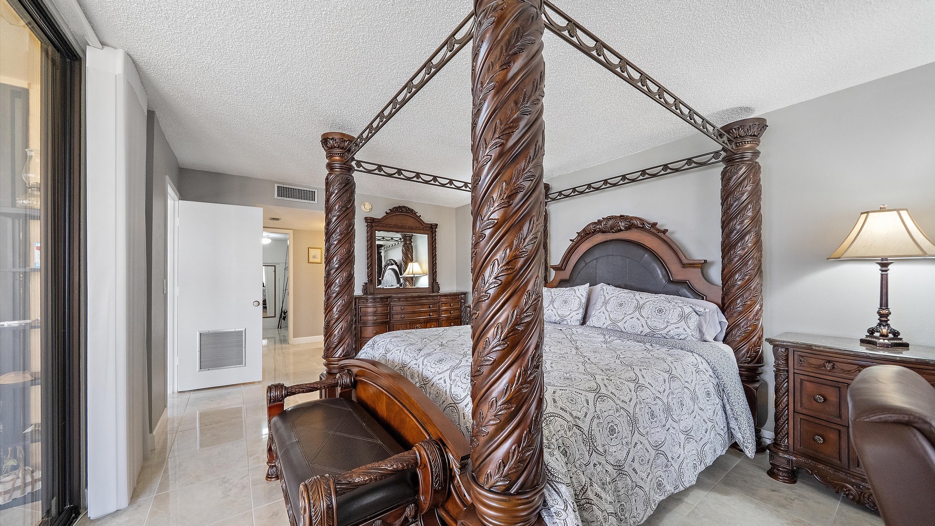 Sink into luxury with this elegant four-poster bed featuring hand-carved columns and premium linens in your private retreat.