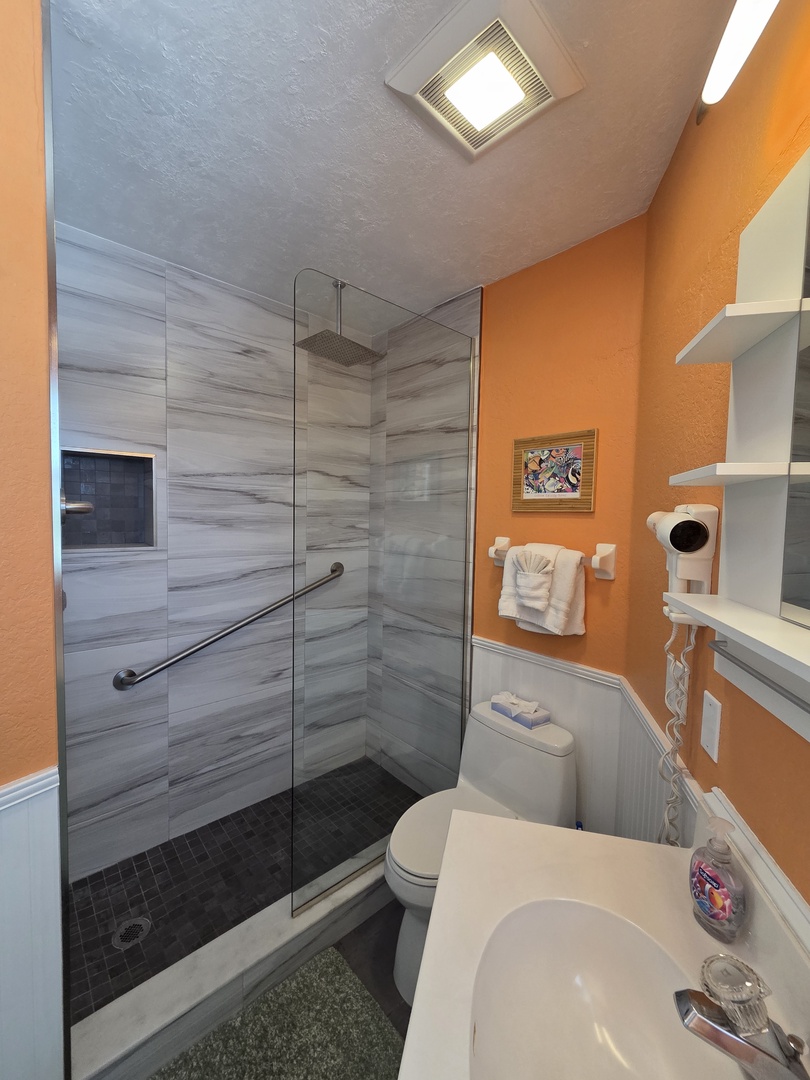 Your private bathroom blends modern style with thoughtful touches—enjoy the spacious walk-in shower, fresh towels, and bright, cheerful design that makes freshening up feel like a treat.