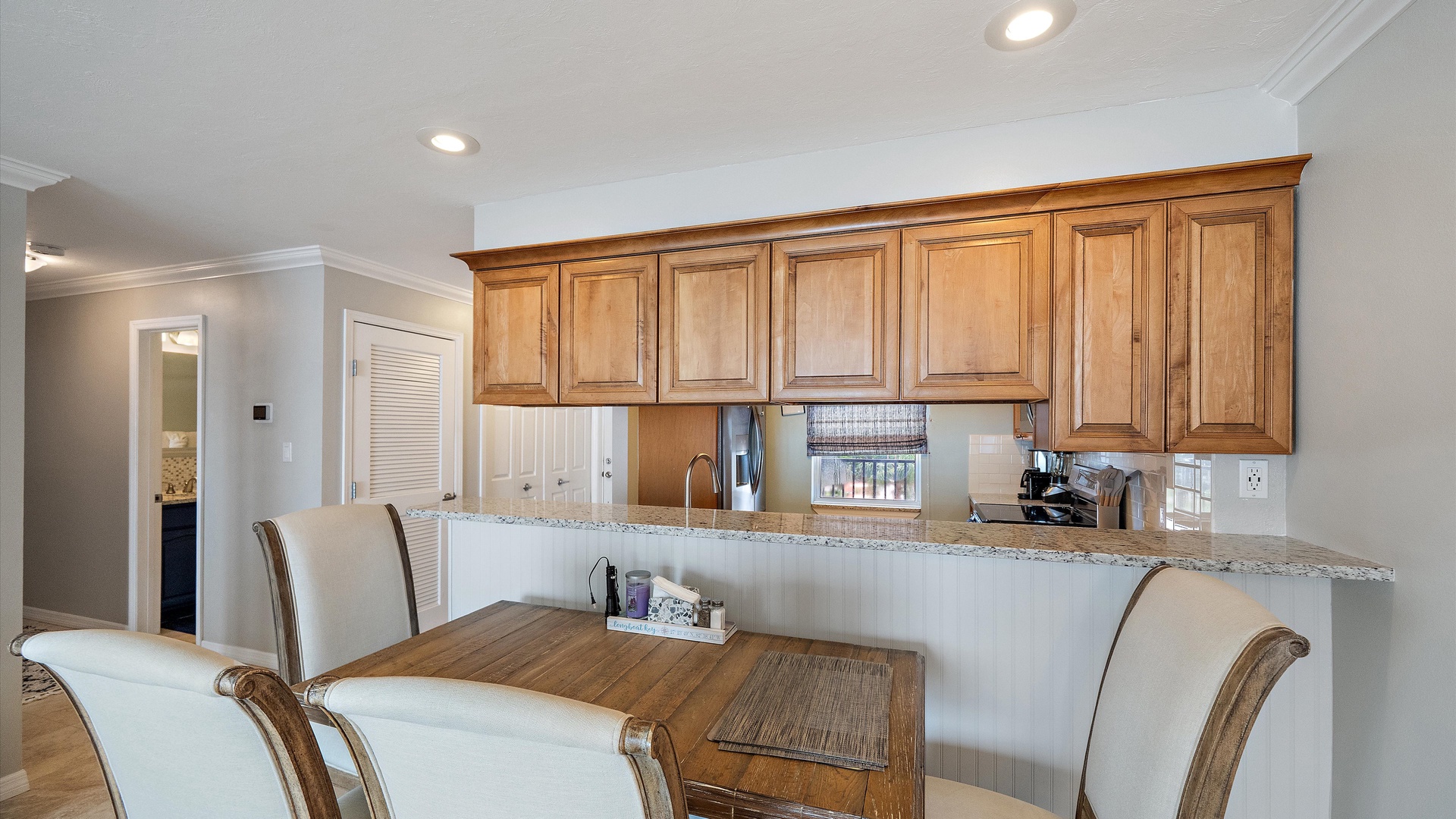 Coastal dining with all the comforts of home. The table seats four beside the kitchen, bringing an easy, welcoming feel to meals at your Longboat Key retreat.