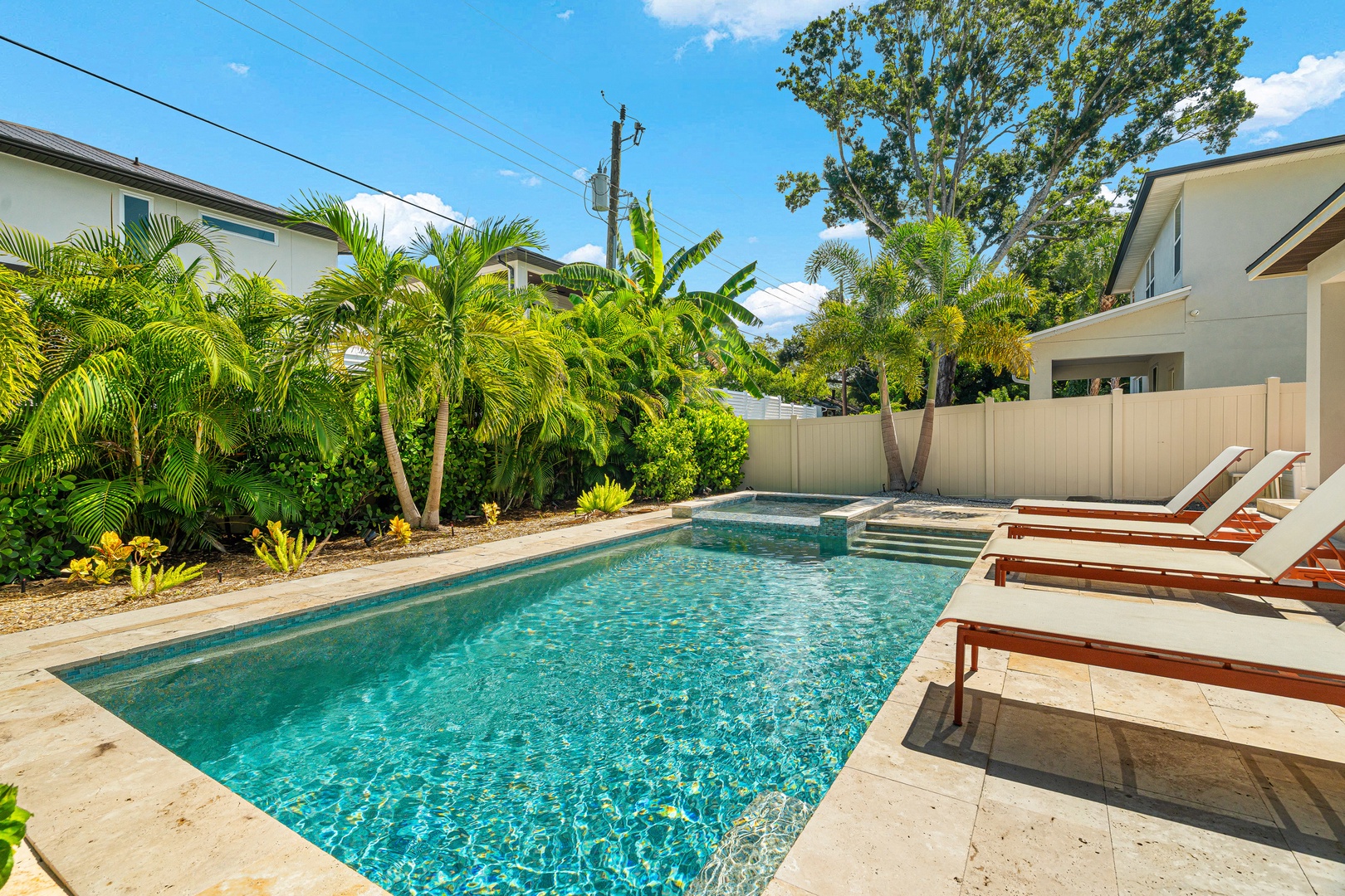 Your private pool awaits, framed by swaying palms and warm sunshine—perfect for soaking up those carefree vacation days. Stretch out on the loungers and let the tropical breeze work its magic.