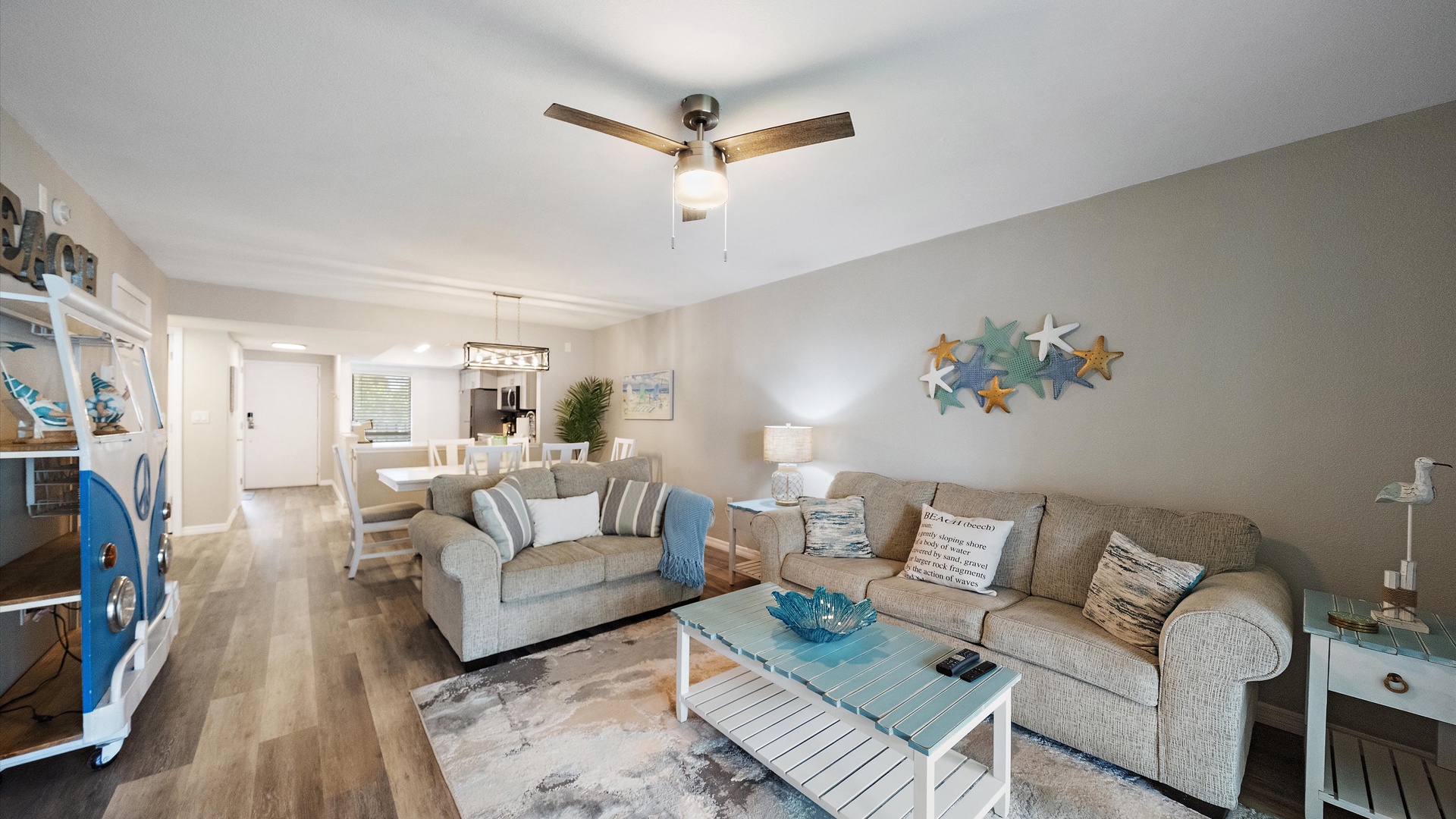 Relax in your bright, beachy living room with coastal touches and comfortable seating that makes unwinding effortless. The open layout connects you to the dining space beyond, perfect for easy entertaining.