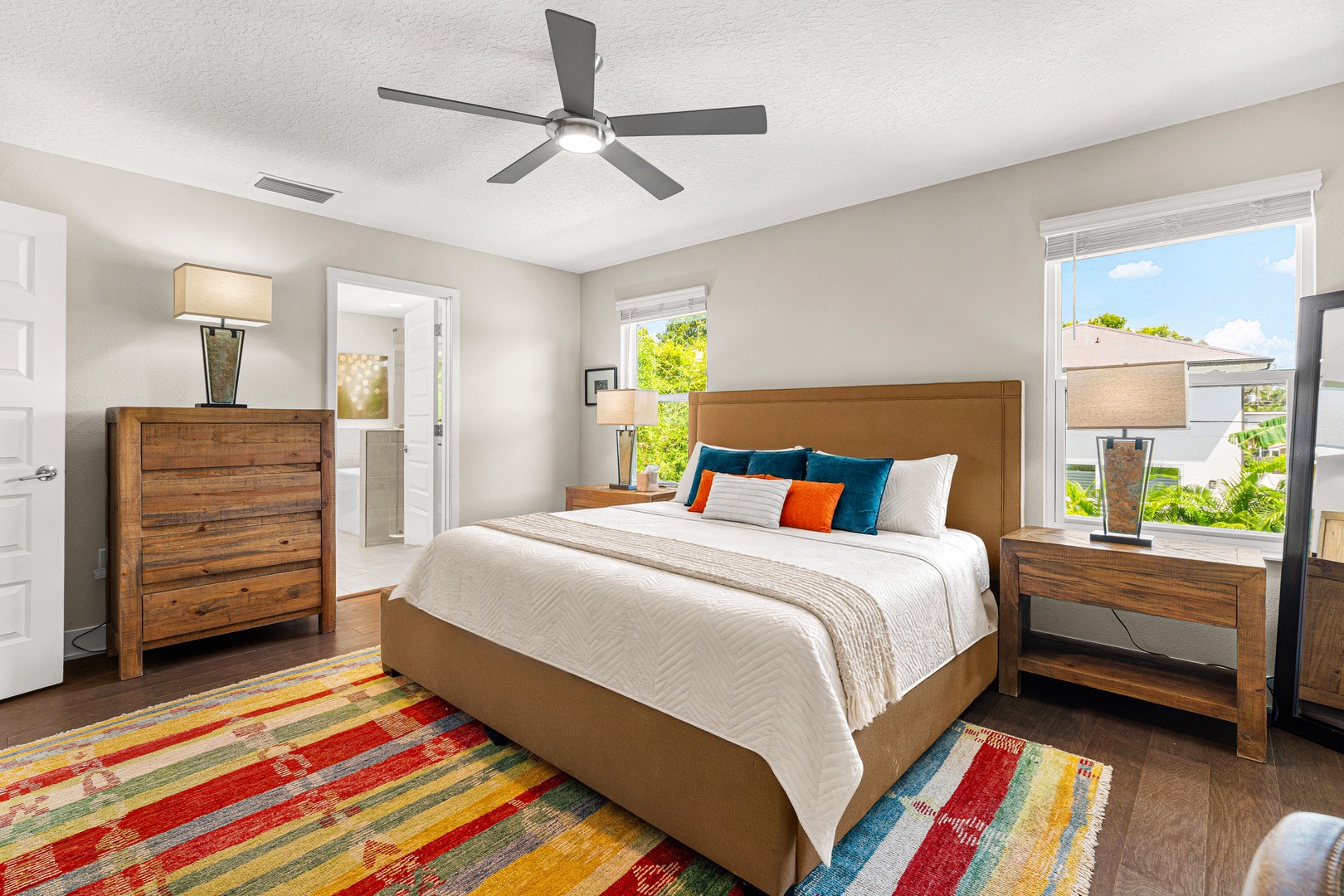 Unwind in the primary king bedroom with hotel-style linens, ensuite bathroom and soaking tub, plush towels, and Smart TV.