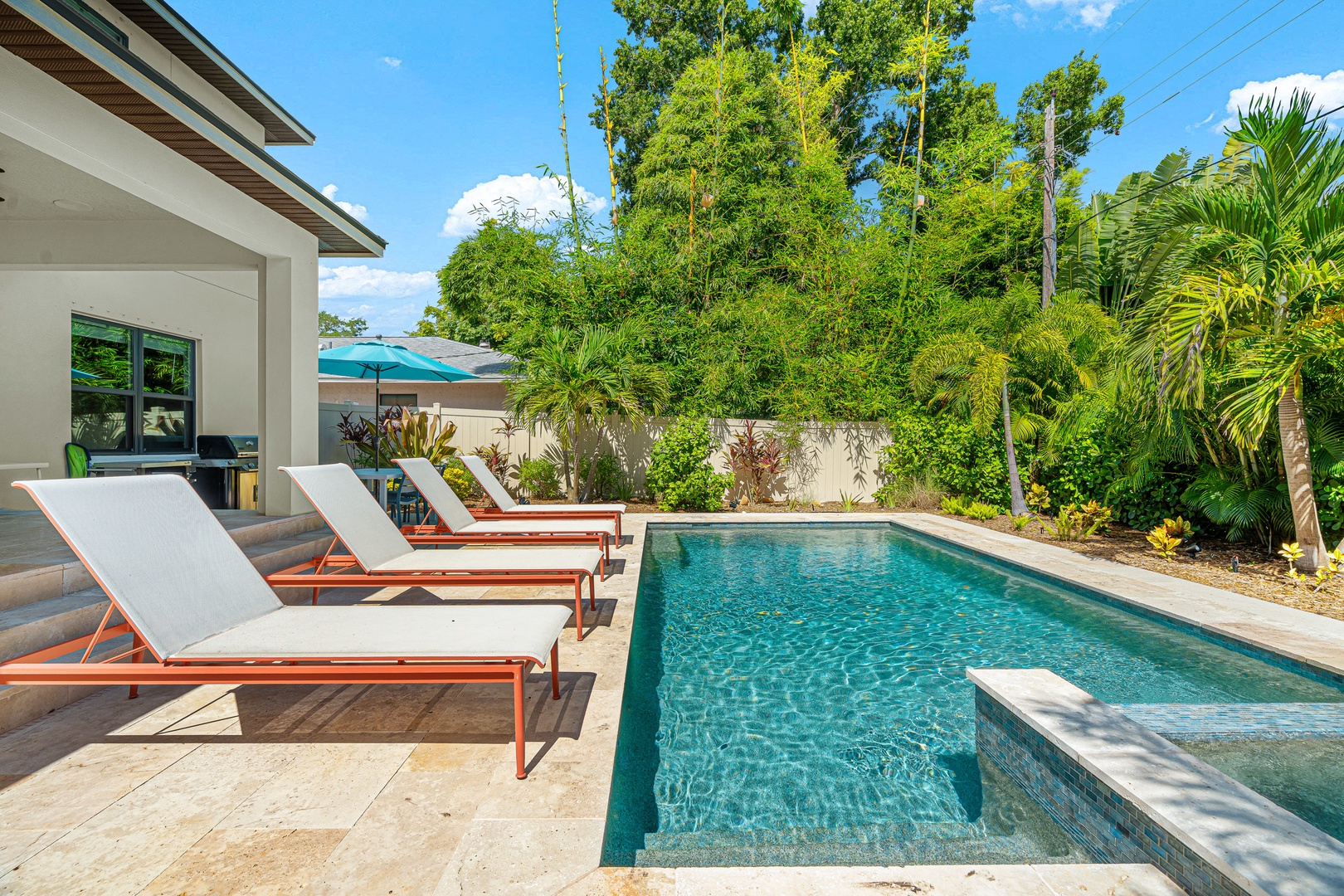 Your private pool oasis awaits, surrounded by lush tropical greenery and comfortable loungers perfect for sun-soaked afternoons. Dive in or simply relax poolside in your own secluded retreat.