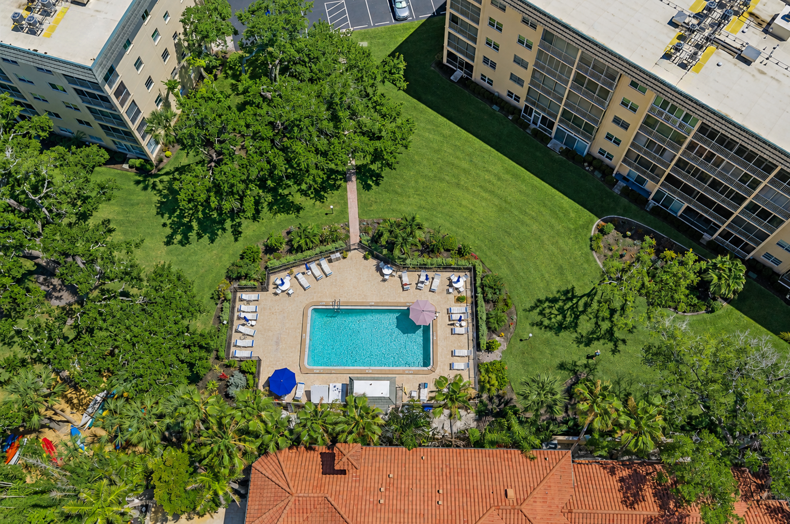Lounge poolside after a day at the beach. Pool loungers and umbrellas available for guest use.