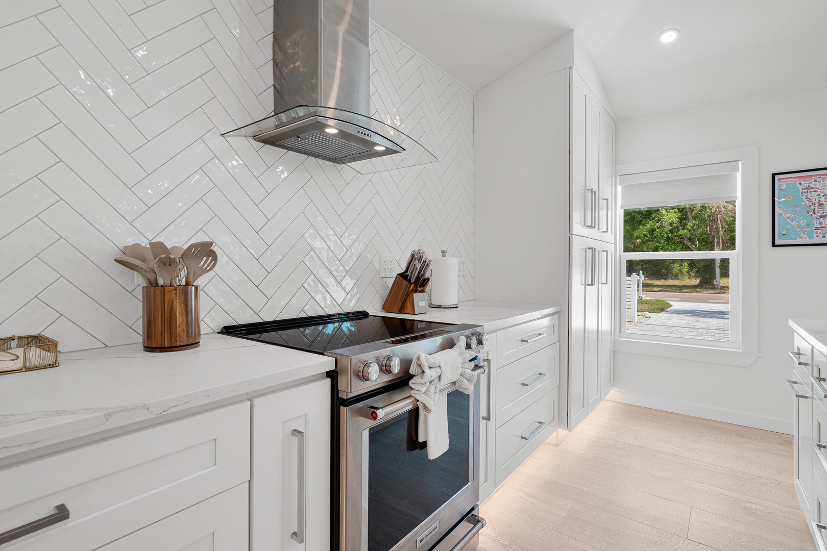Your gourmet kitchen blends sleek design with top-tier appliances, ready for everything from quick breakfasts to full dinner parties. Natural light fills the space through a peaceful garden view.
