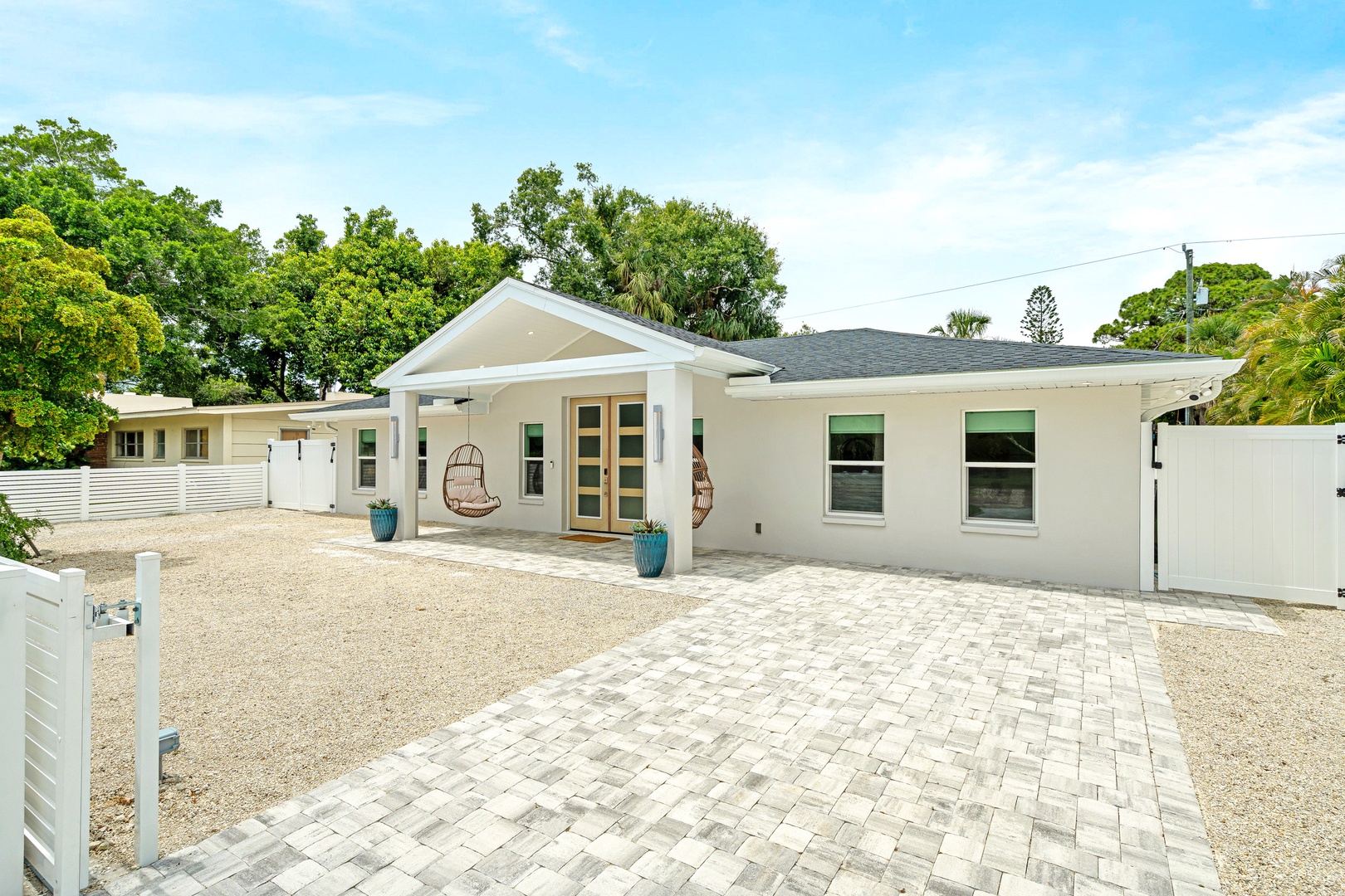 Charming coastal-style home nestled in a peaceful neighborhood with a spacious driveway.