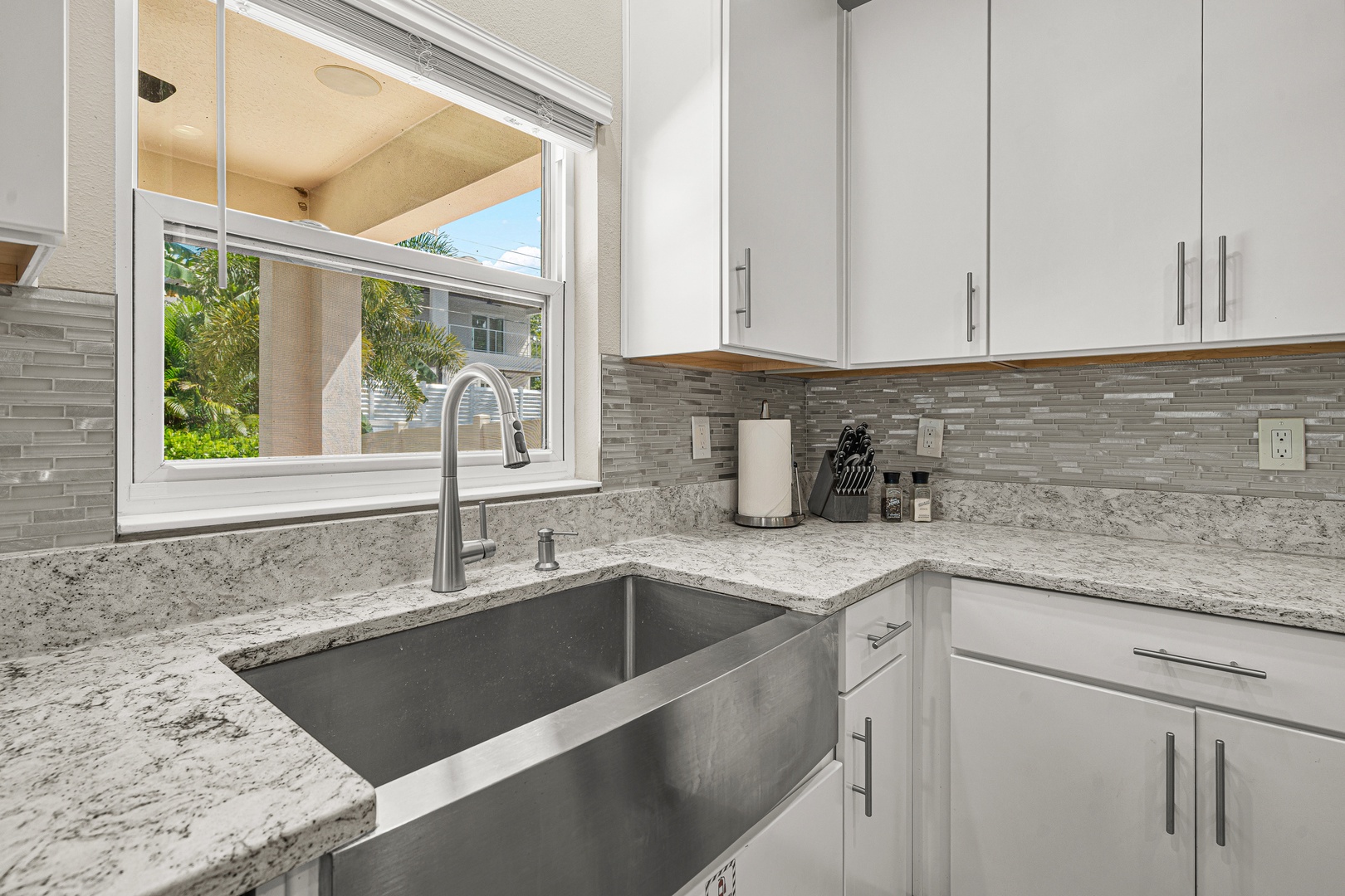 Your modern kitchen features sleek granite counters, a spacious farmhouse sink, and everything you need to prepare meals in comfort and style.
