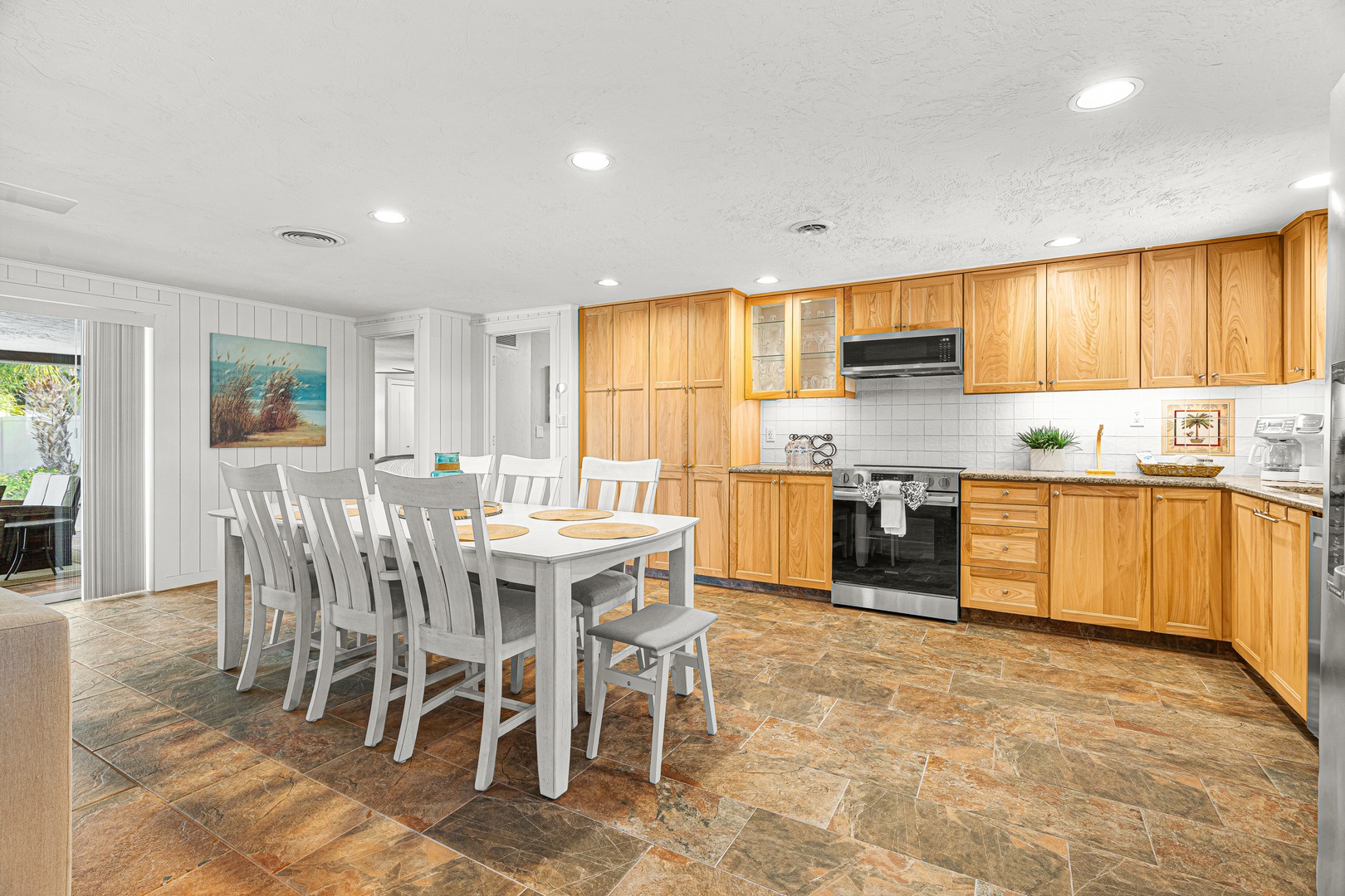 Gather everyone around this spacious dining table where your group can share meals and stories. The fully-equipped kitchen makes it easy to cook together and create vacation memories.