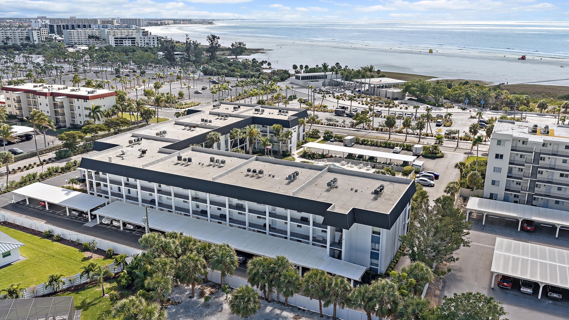 Beachfront property showcasing modern architecture with convenient parking and easy beach access in a vibrant coastal community.