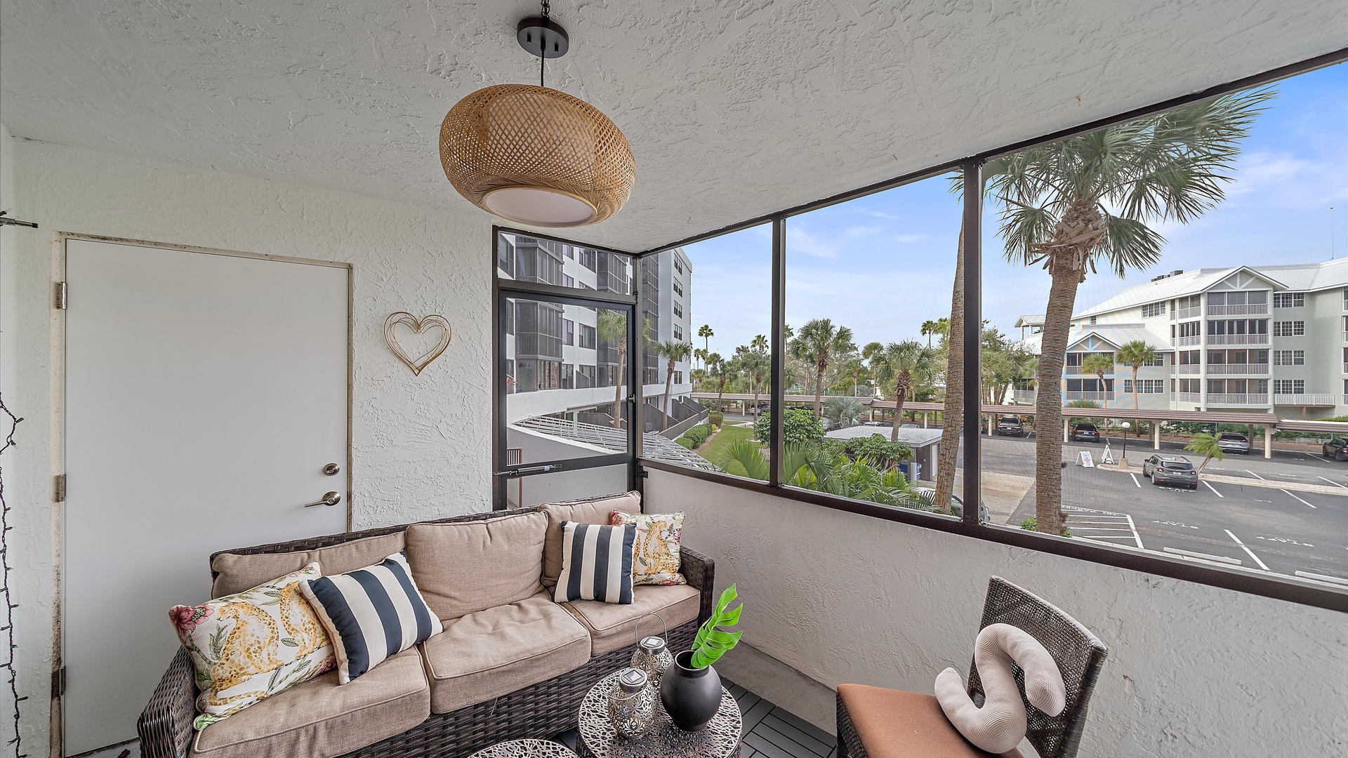 Relax in your private screened balcony with comfortable seating and tropical views - the perfect spot to unwind with your morning coffee or evening drinks.