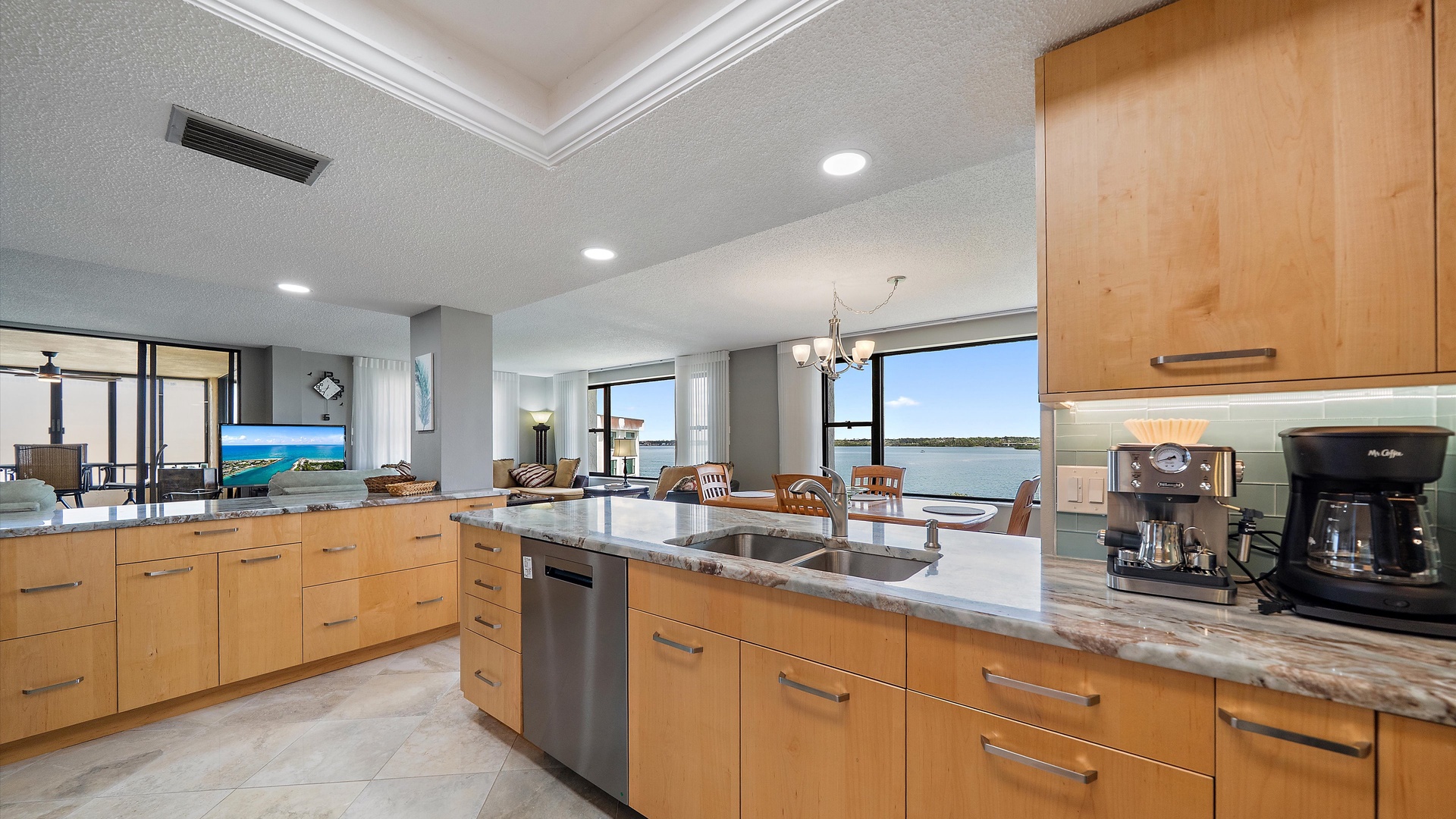 Your gourmet kitchen features granite countertops, warm wood cabinetry, and stunning water views that make cooking feel like vacation dining.