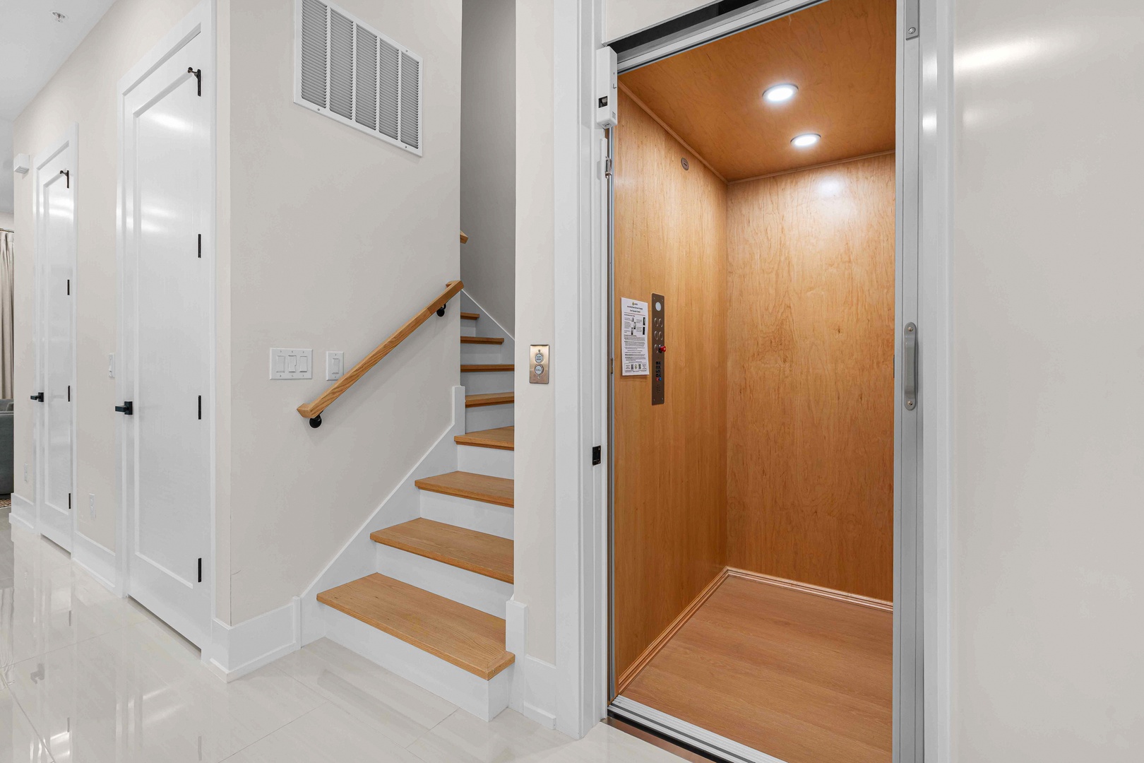 The private elevator offers effortless access to every floor, combining warm wood finishes with modern convenience for your comfort.