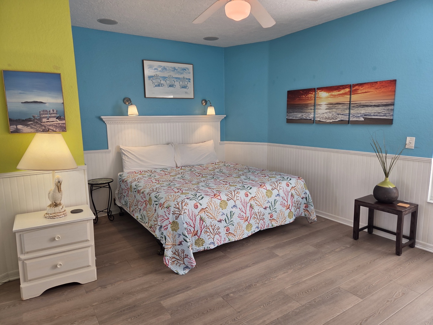 Rest easy in your coastal-inspired bedroom, where cheerful turquoise walls and a plush bed with ocean-themed linens invite you to unwind after a day of adventure.