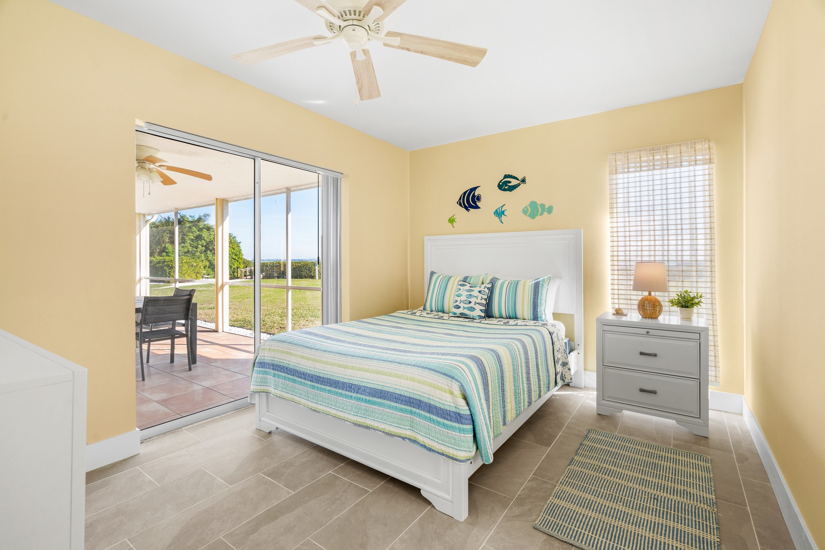 Your coastal-themed bedroom features crisp linens and patio access, creating a breezy retreat for peaceful nights.