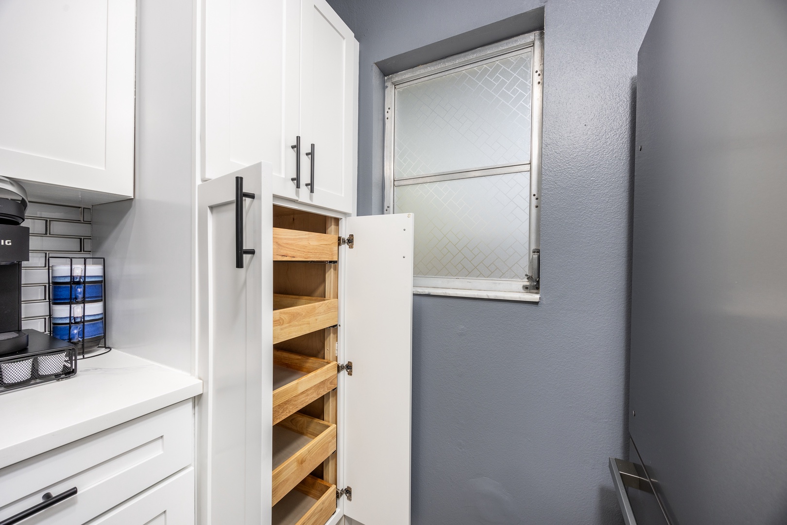 Your kitchen features smart pull-out pantry shelves and custom storage solutions, making meal prep effortless during your stay.