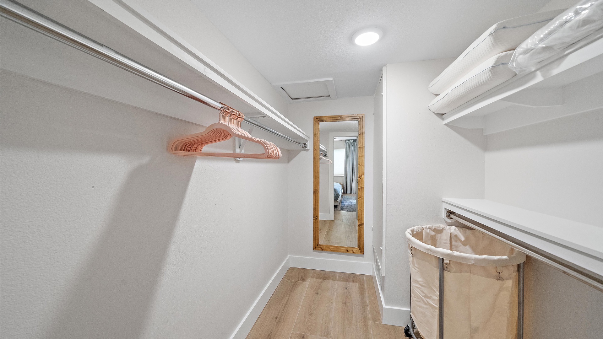 Step into your spacious walk-in closet with ample hanging space and convenient shelving for all your belongings during your stay.