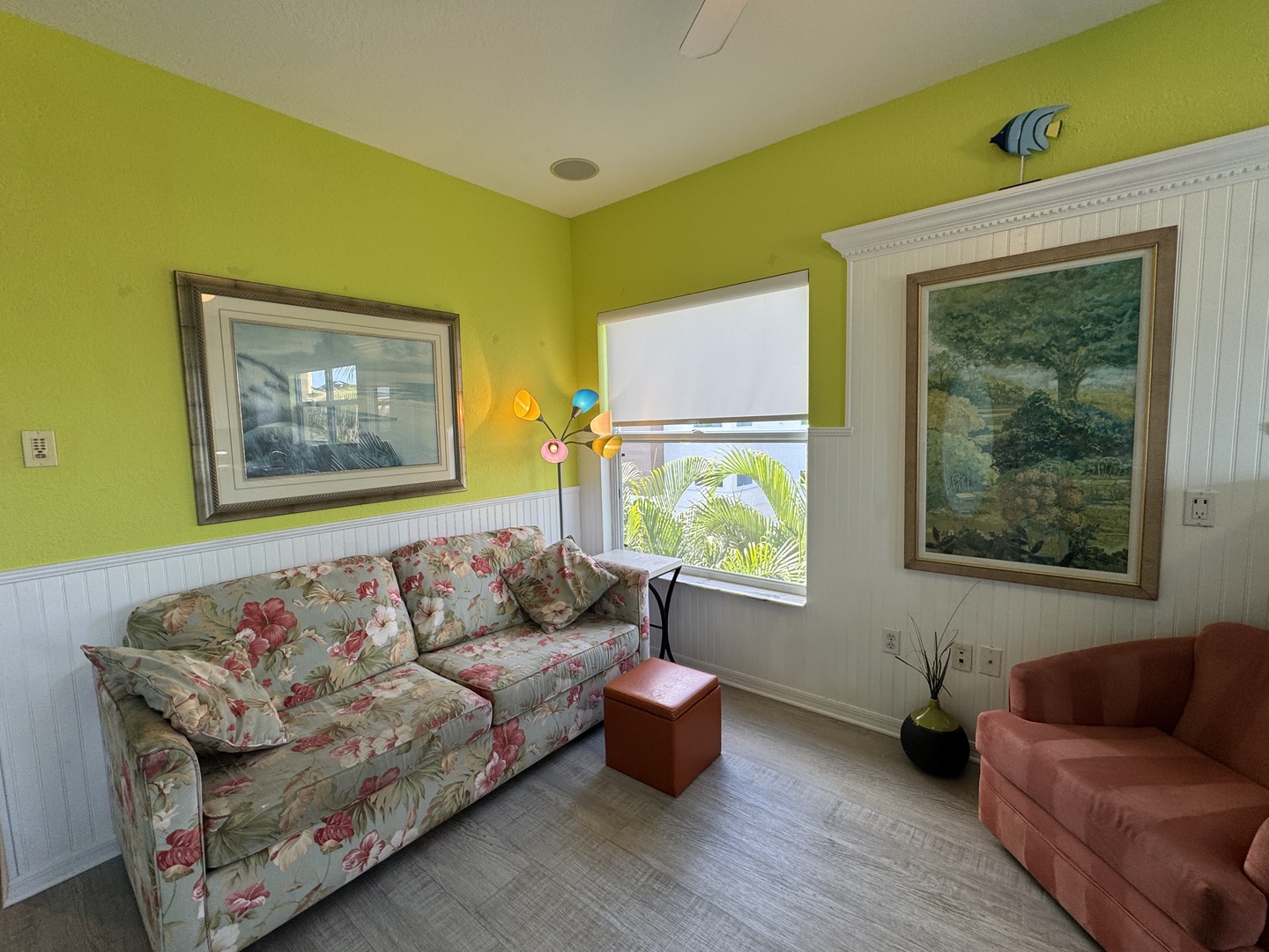 Relax in this cheerful, sun-lit living space with cozy seating and glimpses of tropical palms just beyond your window—your perfect hideaway for unwinding after adventures.