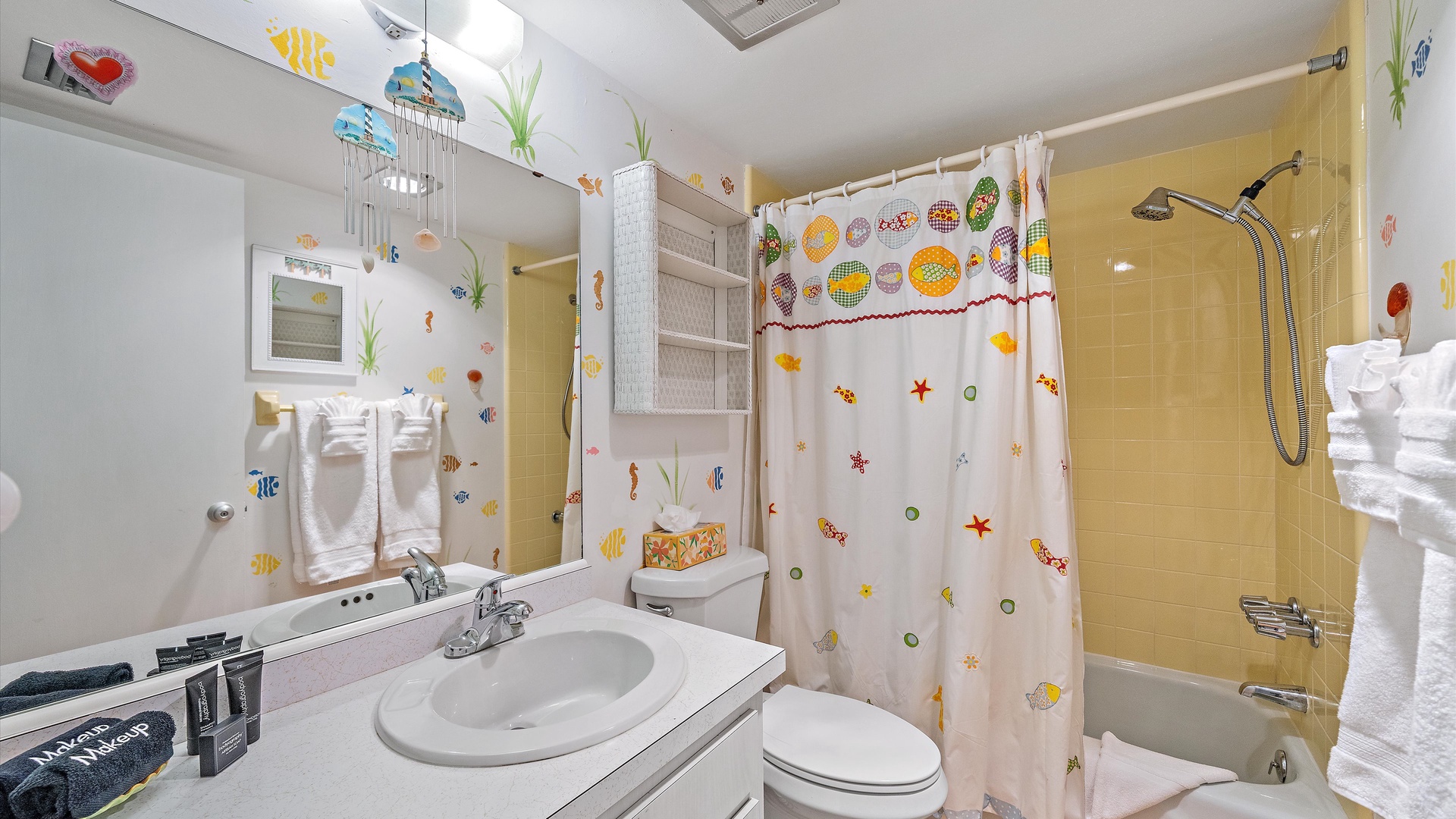 A charming bathroom thoughtfully designed with playful ocean-themed decor, featuring cheerful fish and sea life. You'll find all the essentials with a fresh, family-friendly atmosphere.