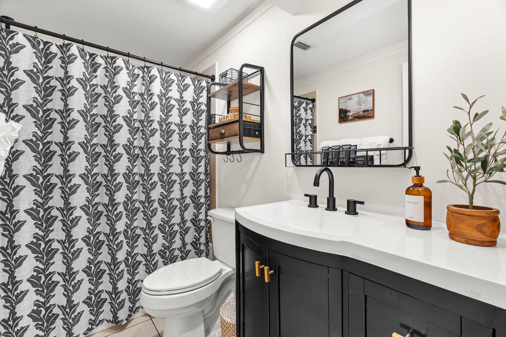 Refresh yourself in your stylish bathroom, where modern black fixtures and thoughtful touches create a sleek, calming retreat after a day of exploring.