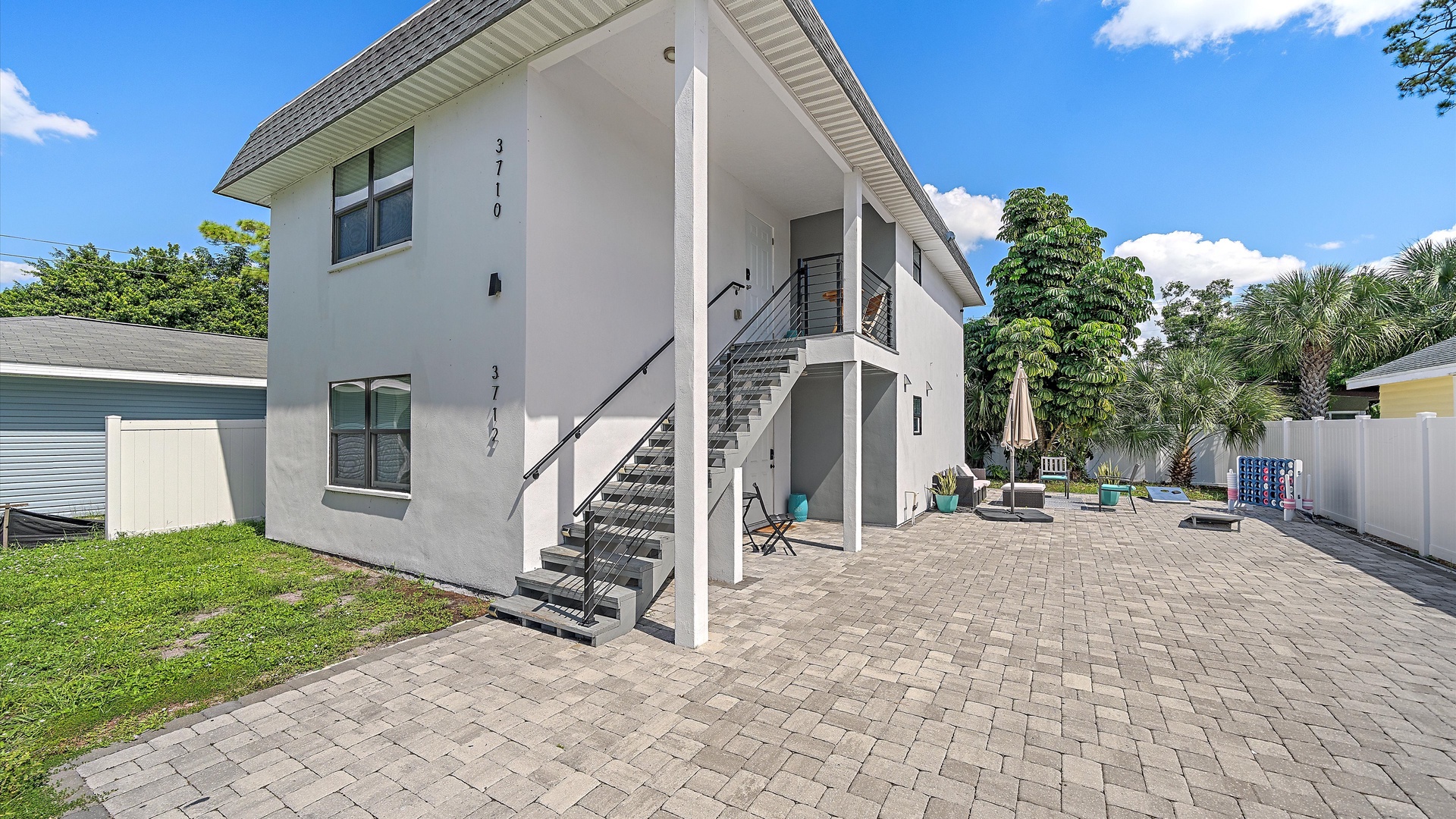 Modern two-story building offering private, easy-access entrances in a peaceful residential setting with tropical landscaping.