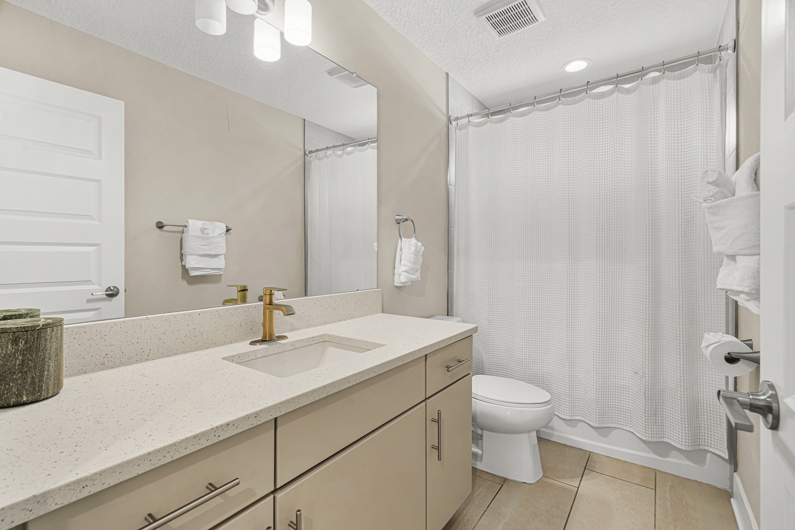 Freshen up in your modern bathroom with soft linens, a spacious vanity, and a bright, clean design that makes every morning feel like a fresh start.