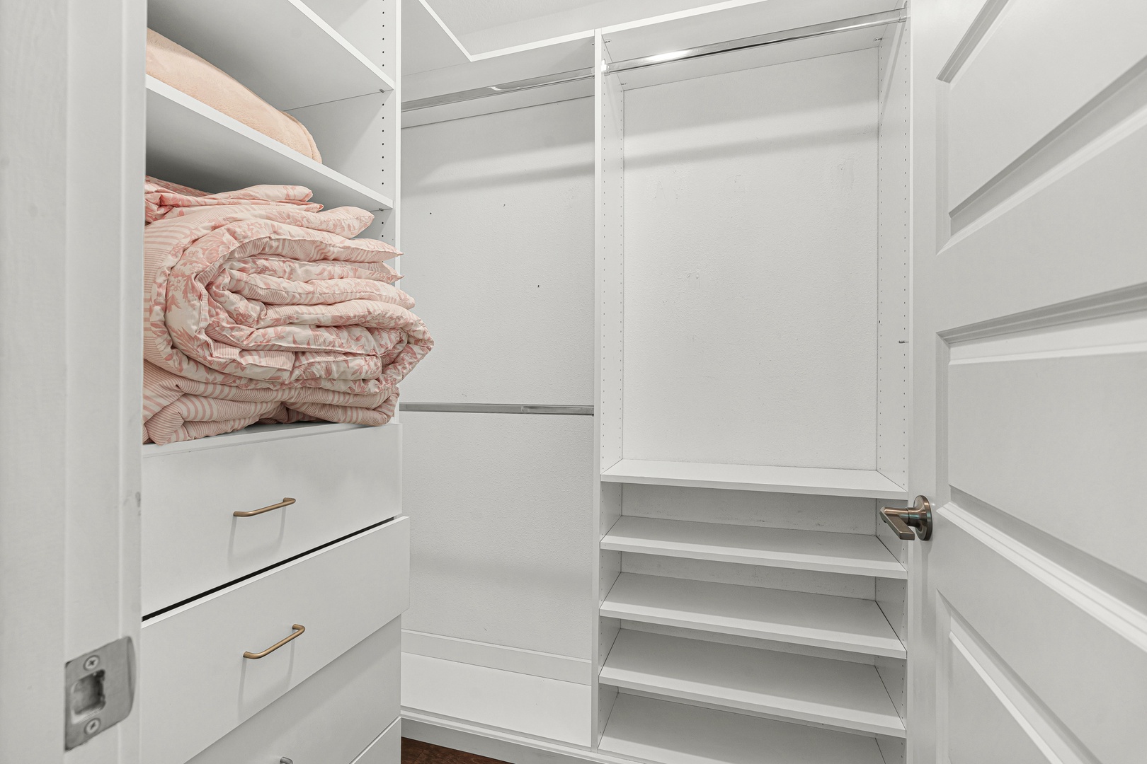 Your wardrobe stays beautifully organized in this spacious walk-in closet, complete with built-in shelving, hanging rods, and soft-close drawers to keep your belongings tidy throughout your stay.