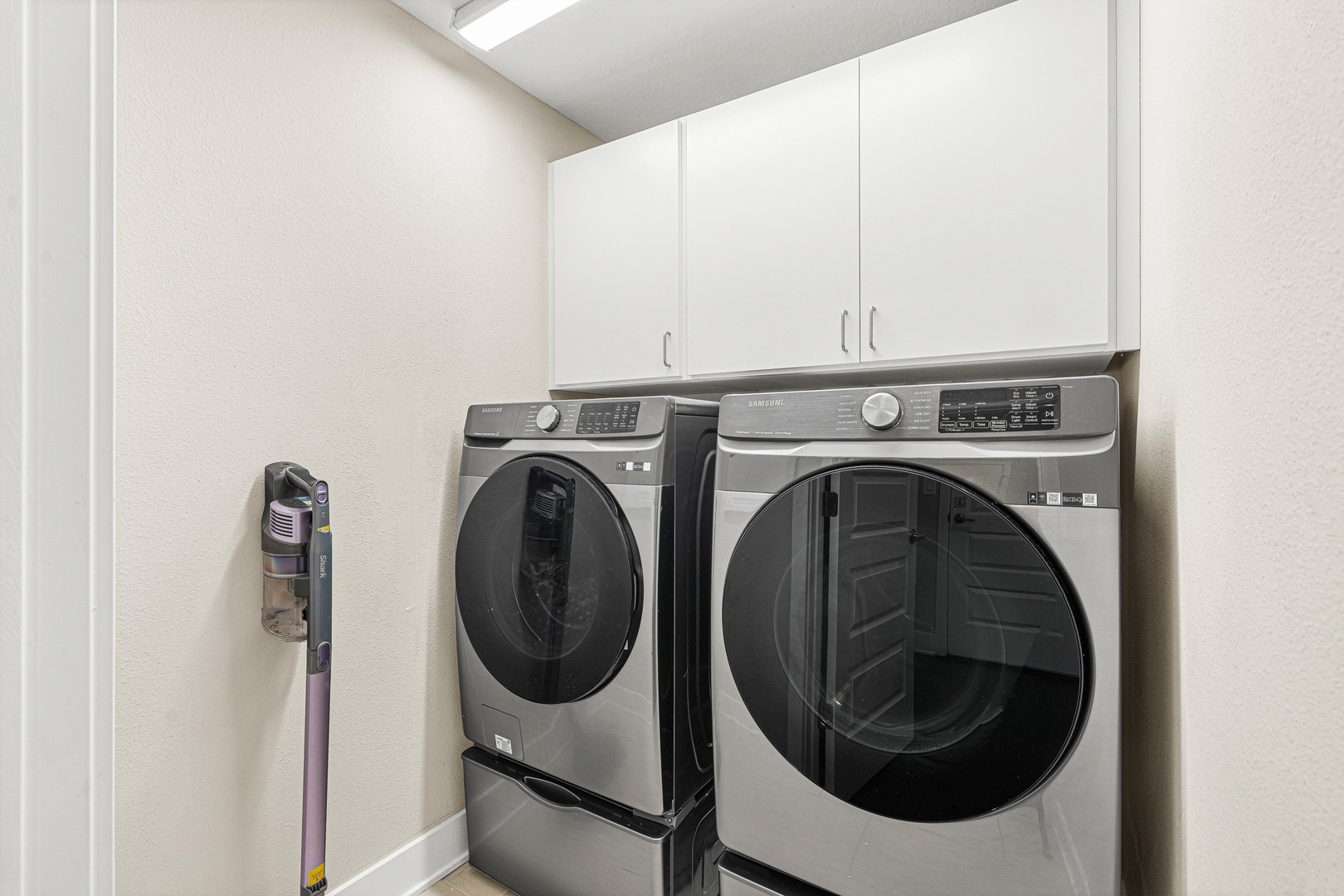 Your in-unit laundry room features modern front-loading machines and overhead storage, making it easy to refresh your wardrobe during your stay.