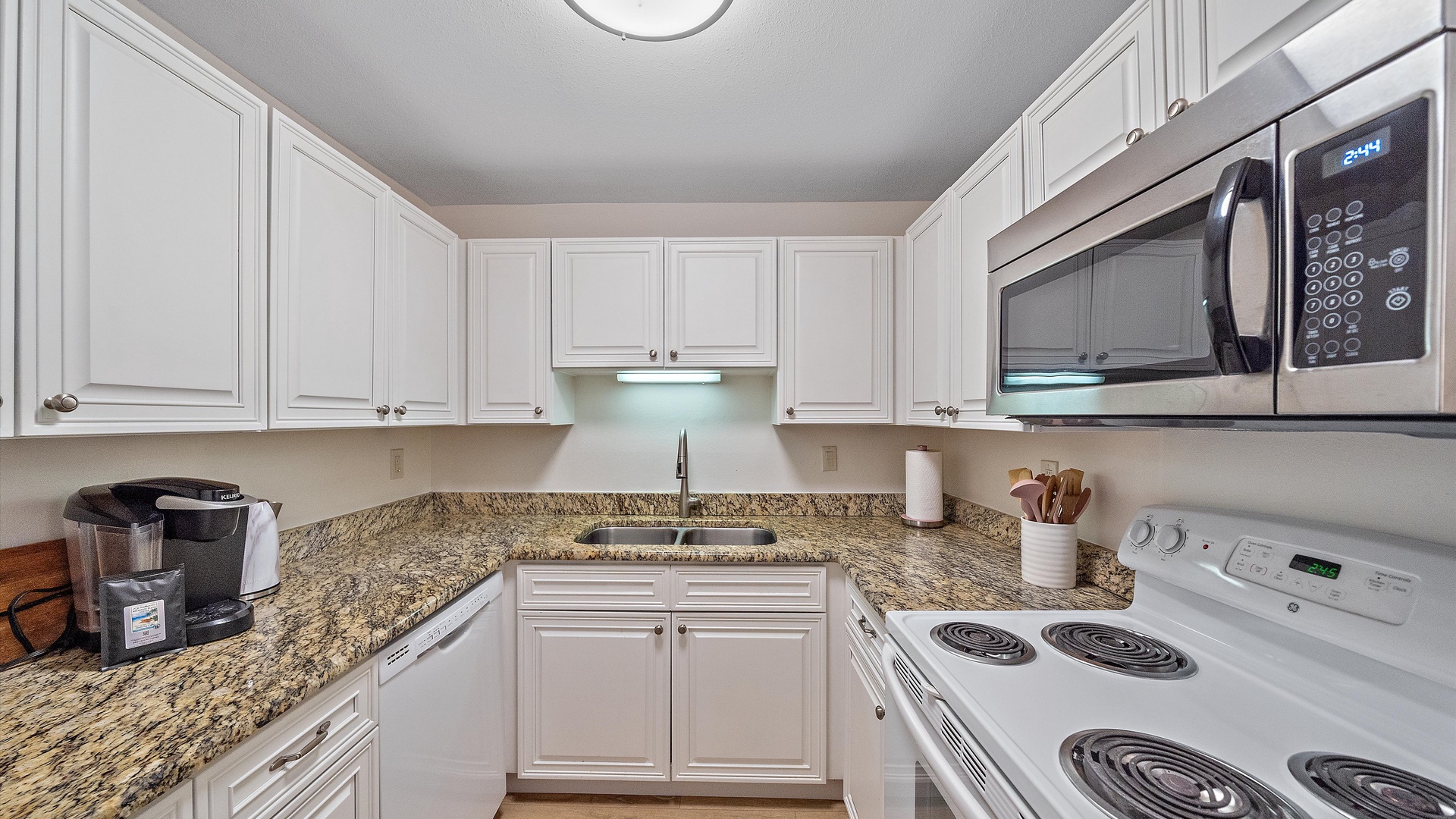 Your fully equipped kitchen features granite countertops, white cabinetry, and all the appliances you need to prepare meals during your stay.