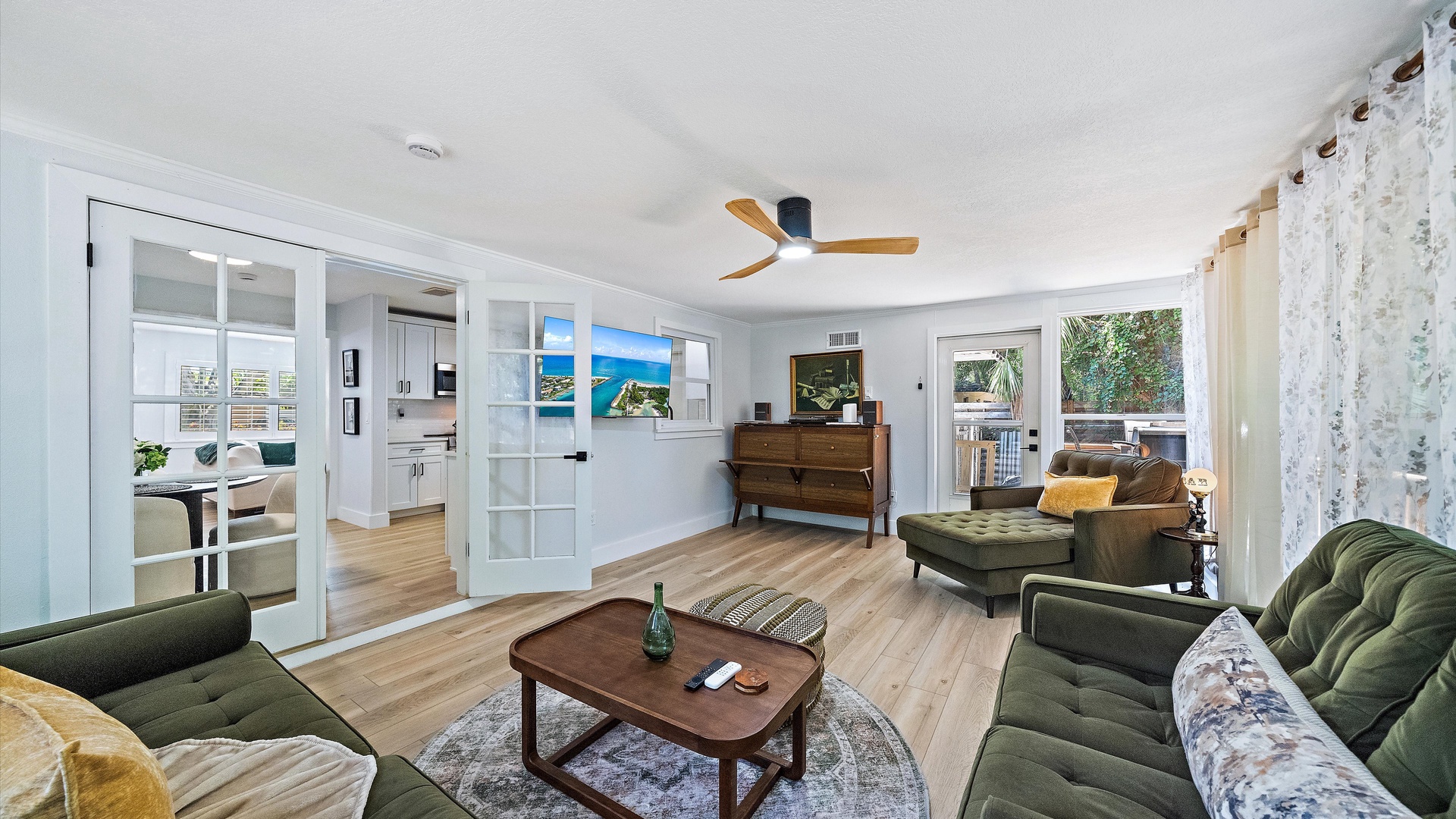 Your spacious living room flows seamlessly through elegant French doors to your bright kitchen and dining areas. Sink into plush seating and let coastal breezes from the balcony refresh your days.