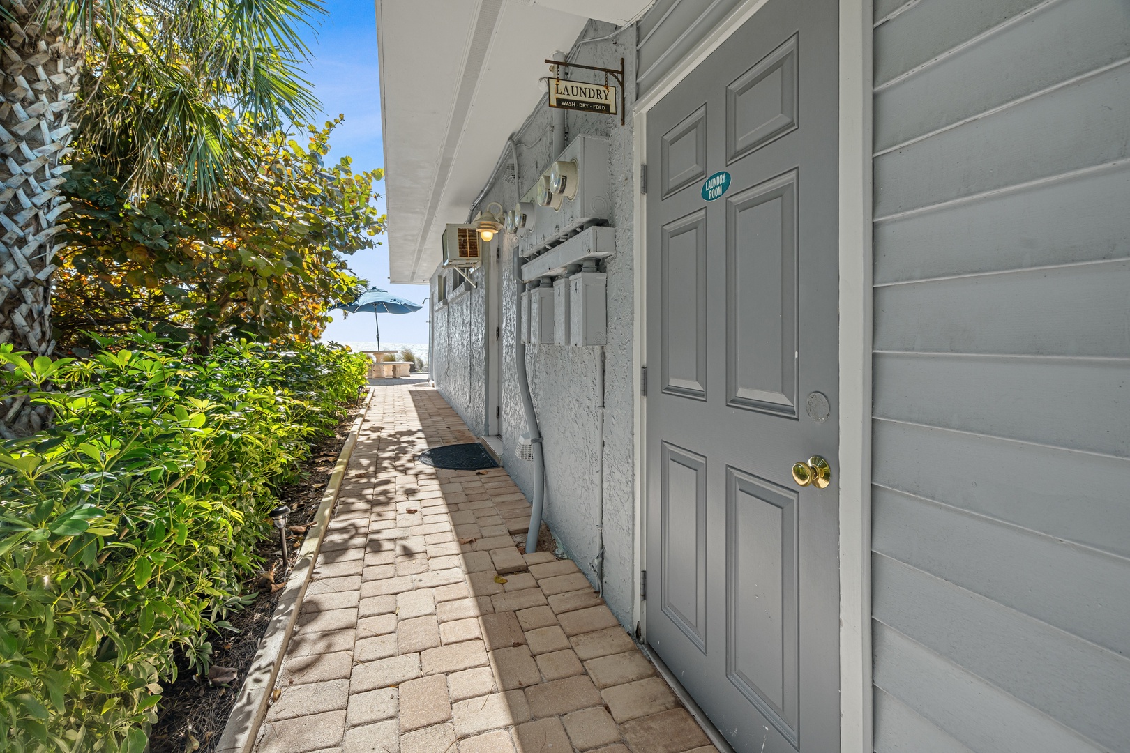 Charming walkway leads to your private entrance, surrounded by lush tropical landscaping and peaceful garden views.
